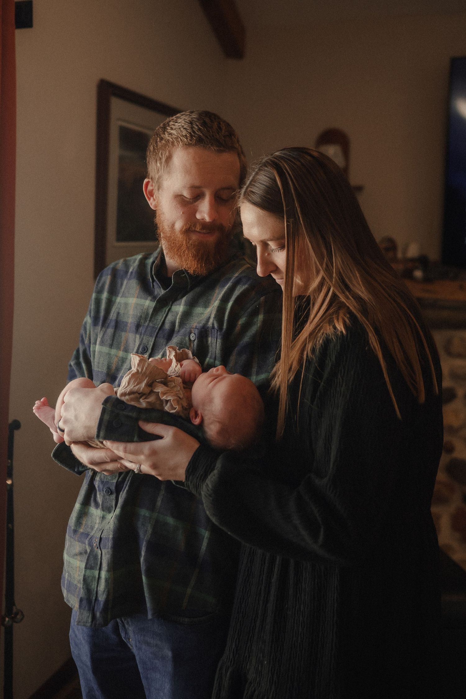 A series of intimate family moments showing tender embraces in a dimly lit room.