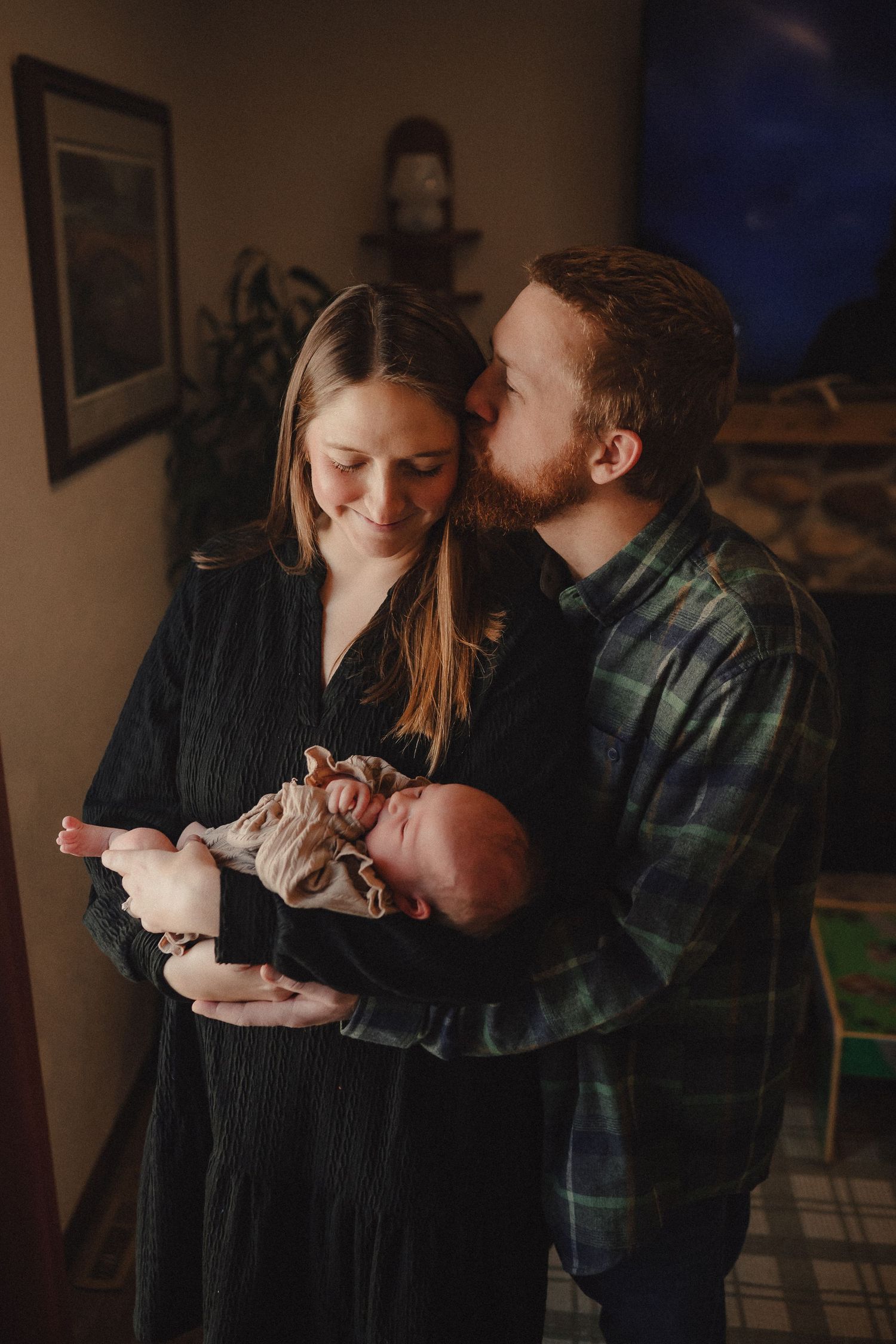 A series of intimate lifestyle photos capturing tender moments between a couple in warm indoor lighting.
