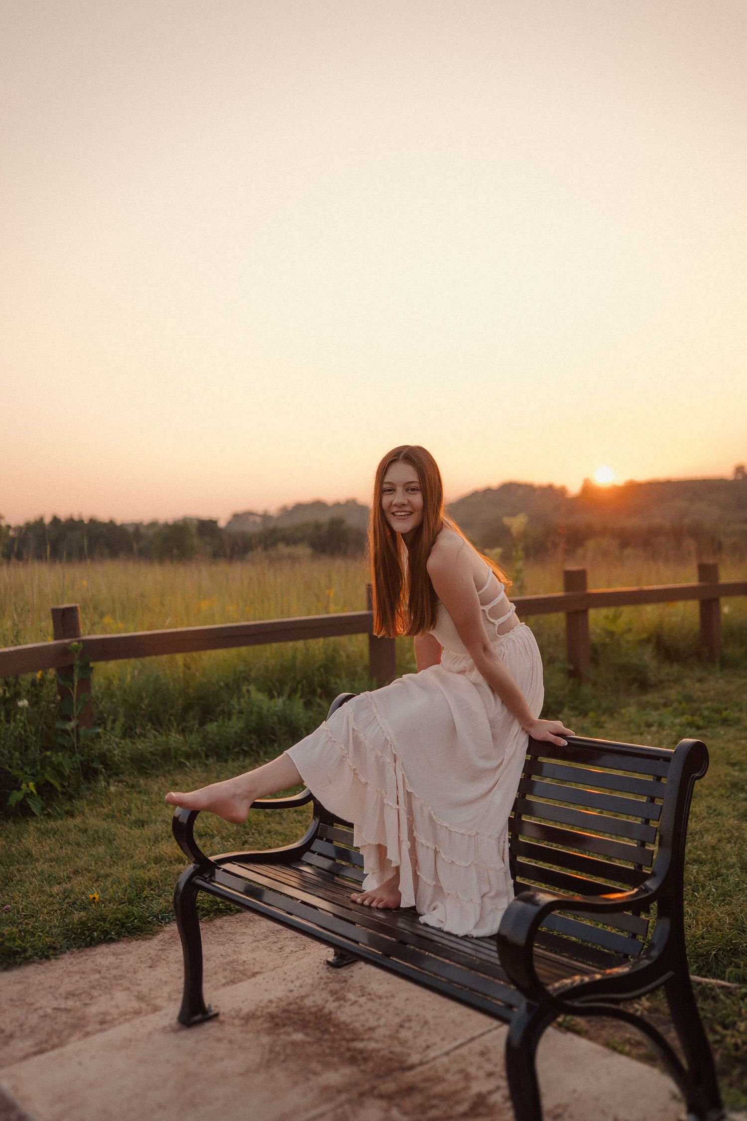 A series of sunset photos showing someone in a white dress posing on a wooden bench in a rural setting.