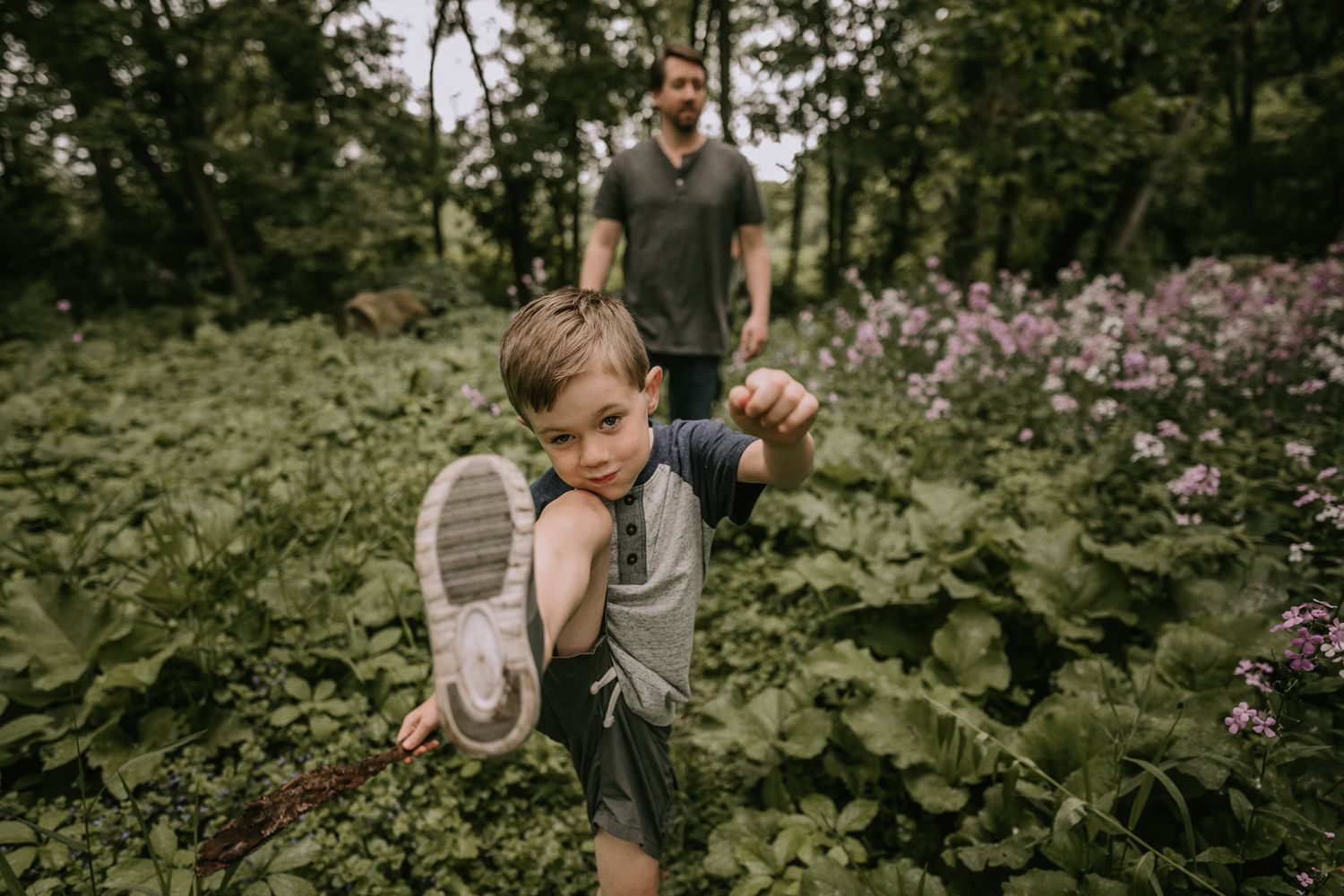 Playful action shot in garden with flowering plants and greenery.