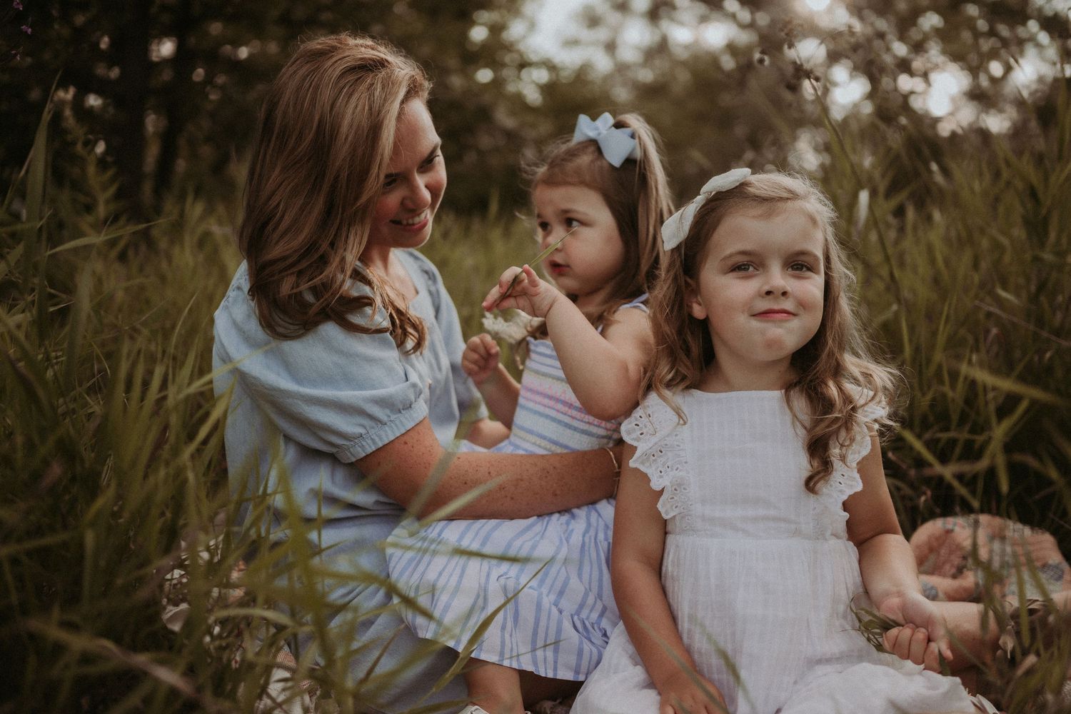A sweet outdoor family moment captured in golden evening light.
