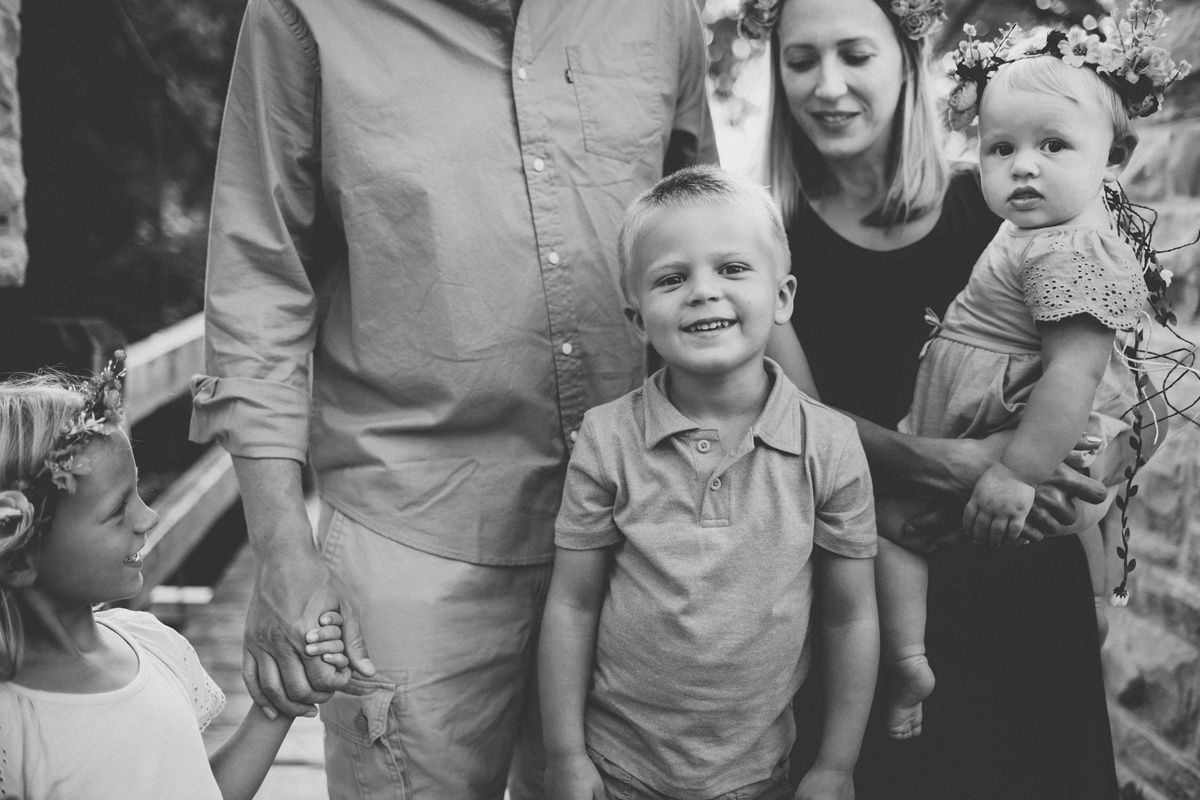 Black and white candid family portrait taken outdoors during a casual gathering.