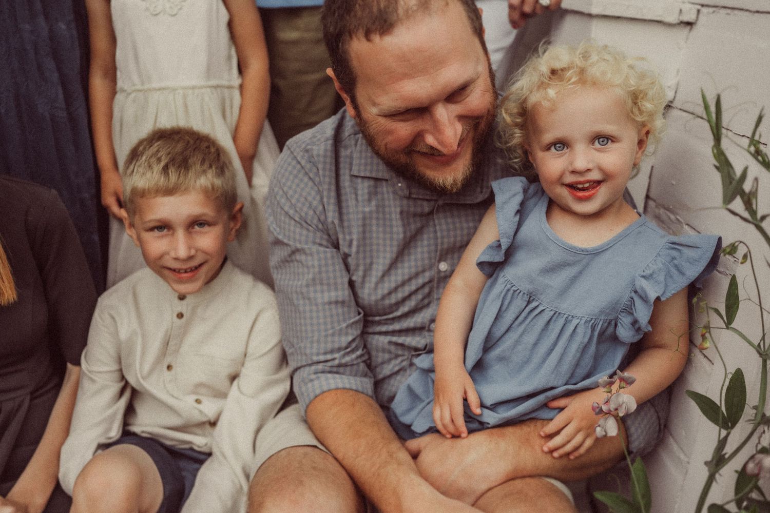 A cheerful moment captured on the farmhouse porch steps on a summer day.