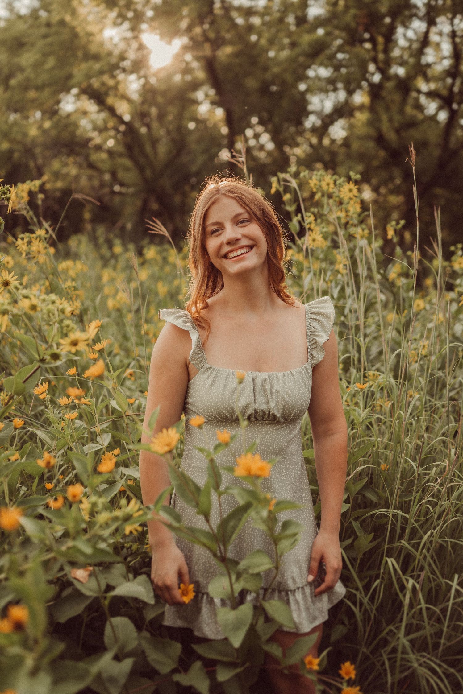 Golden hour portrait in a wildflower field wearing a light summer dress.