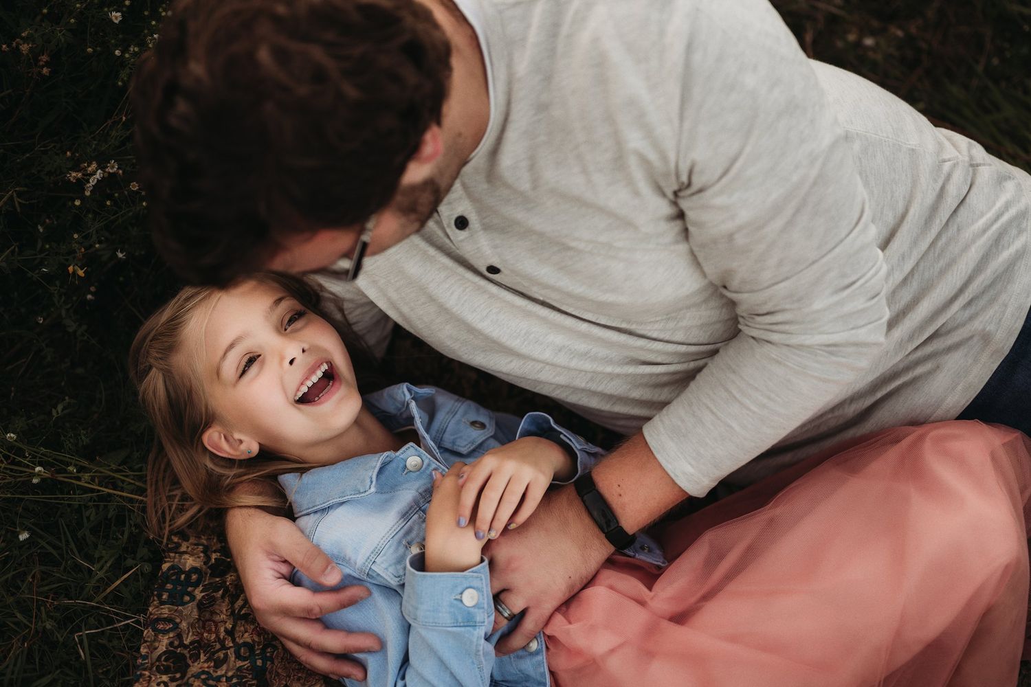 A candid moment of laughter and joy captured during an outdoor photo session.