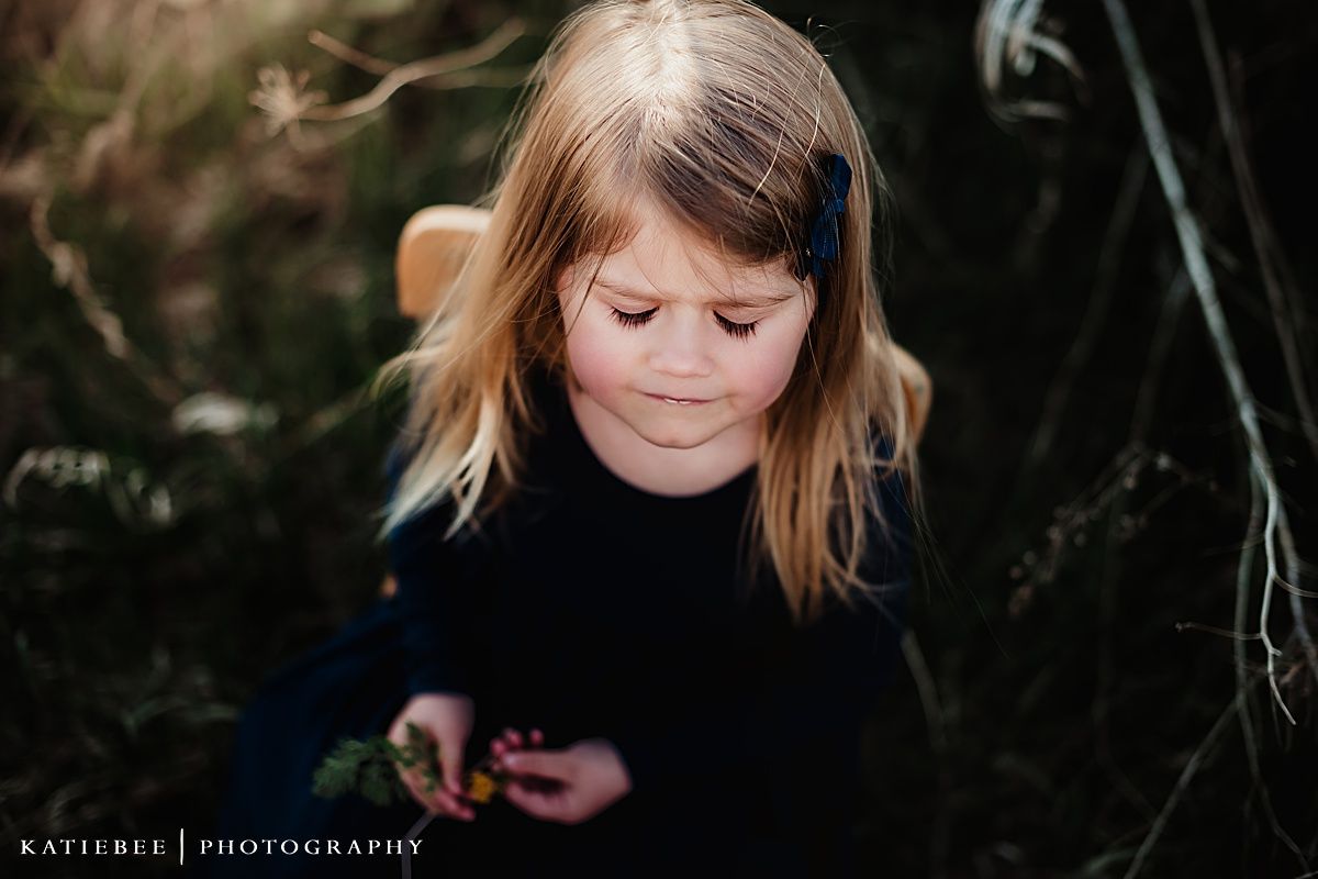 Intimate portrait of child looking down in natural lighting.