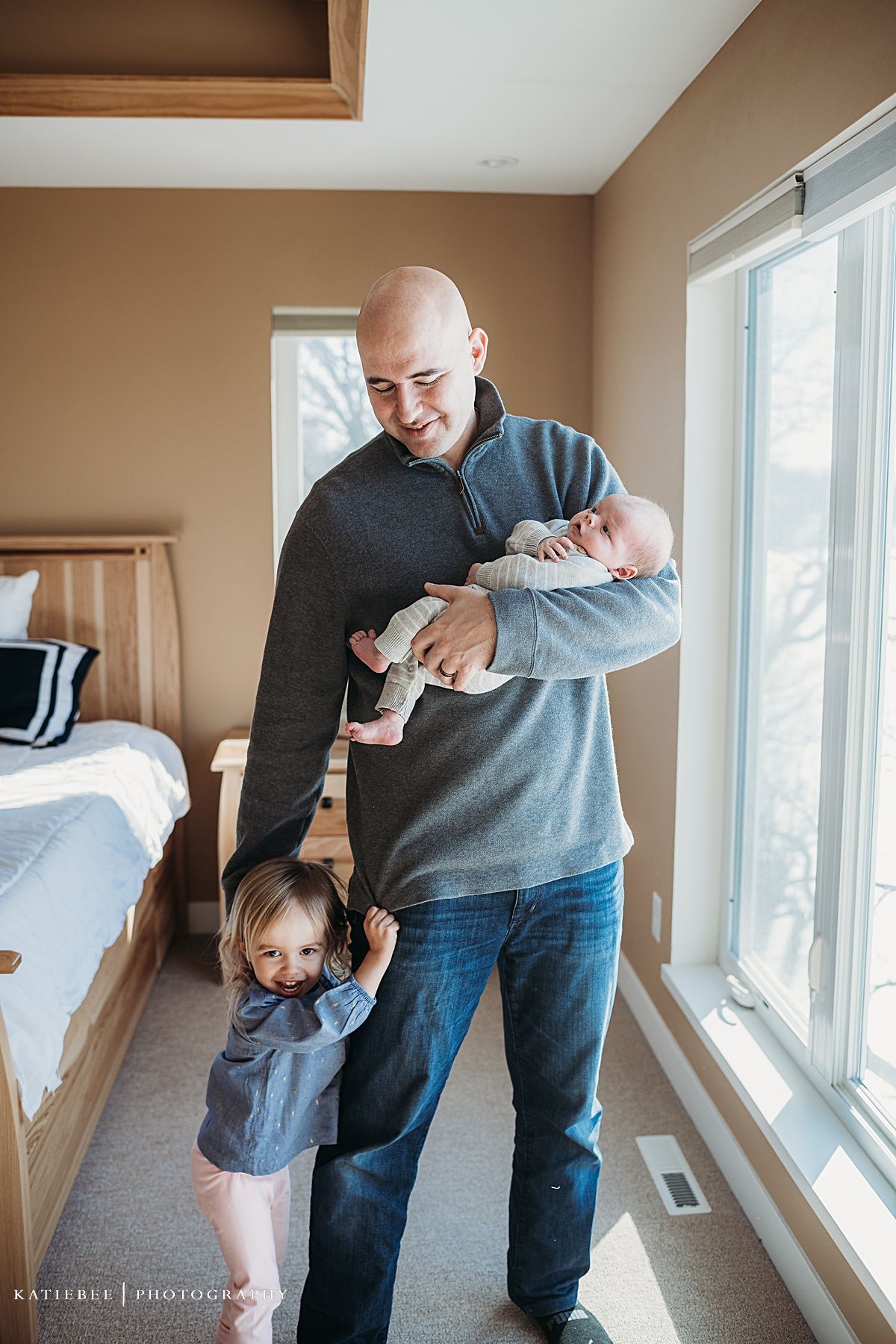 Happy moment in sunlit bedroom with family.