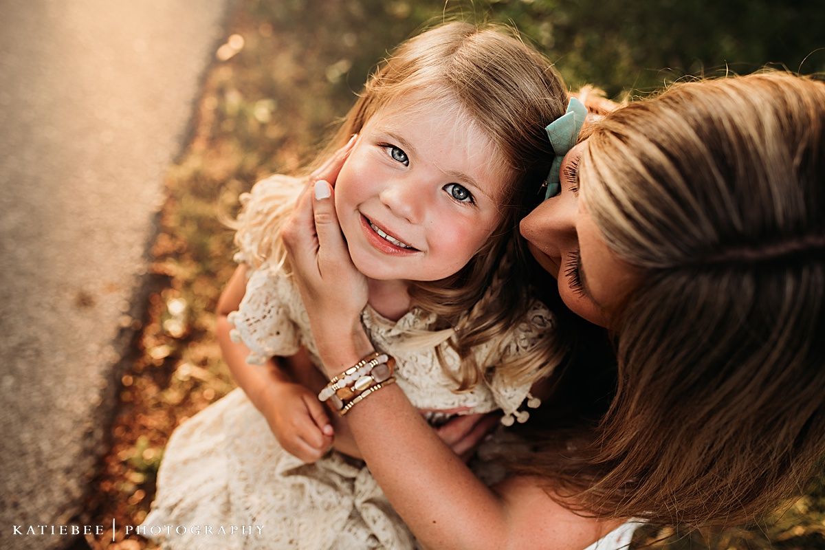 Close-up candid portrait showing tender moment between parent and child.