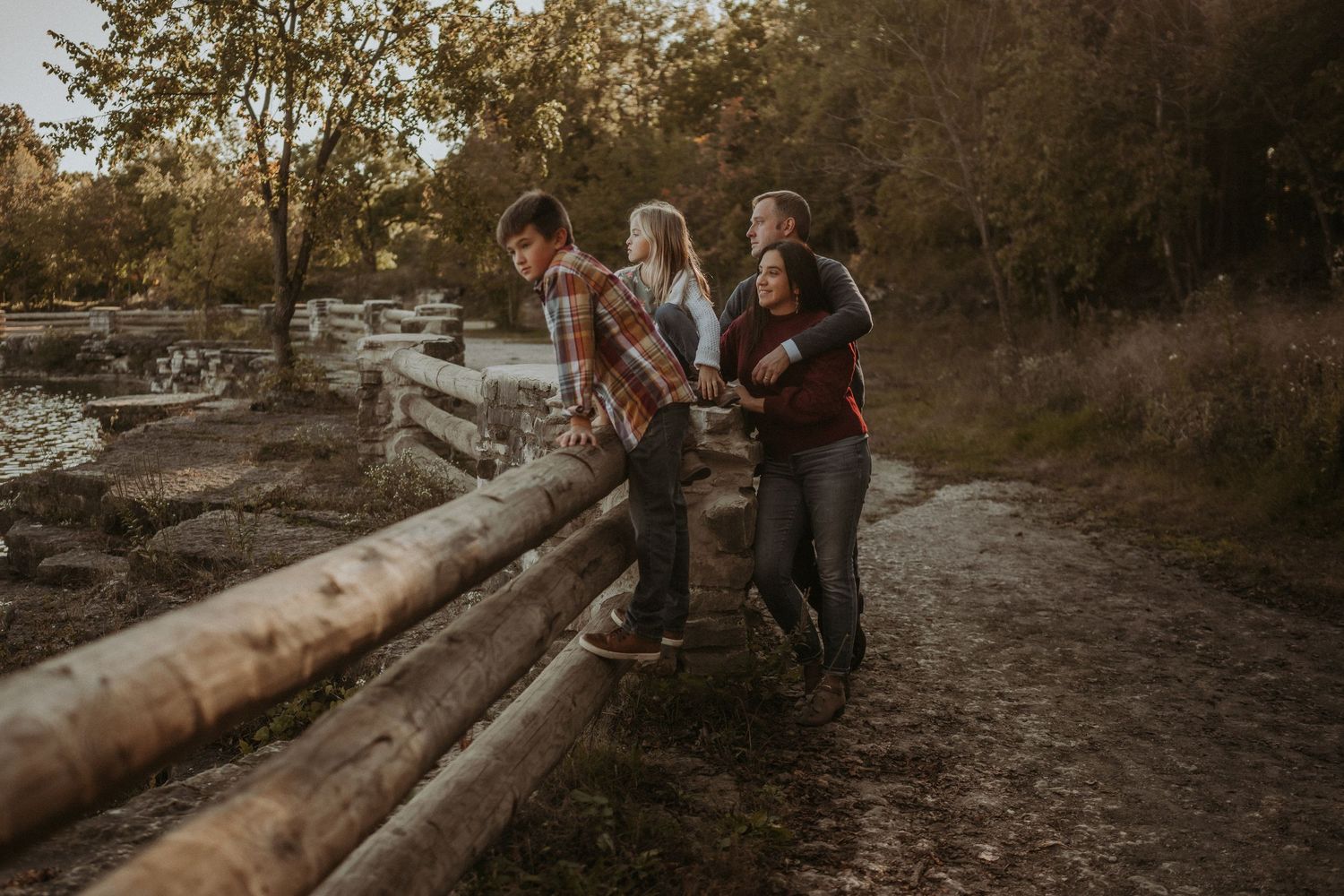 Group enjoying sunset together while sitting on wooden logs in nature.
