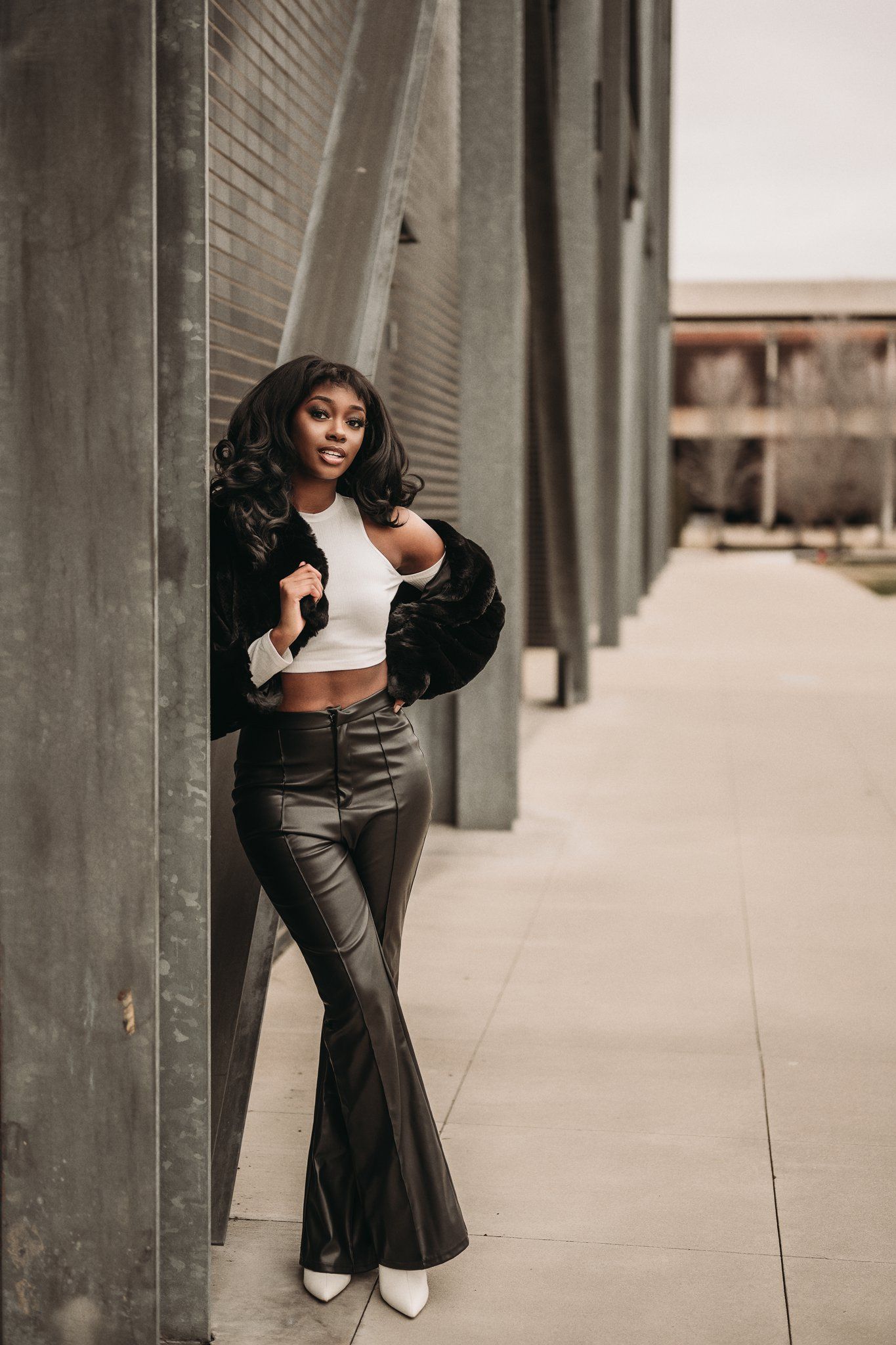 Stylish fashion portrait featuring modern architecture and urban aesthetics.
