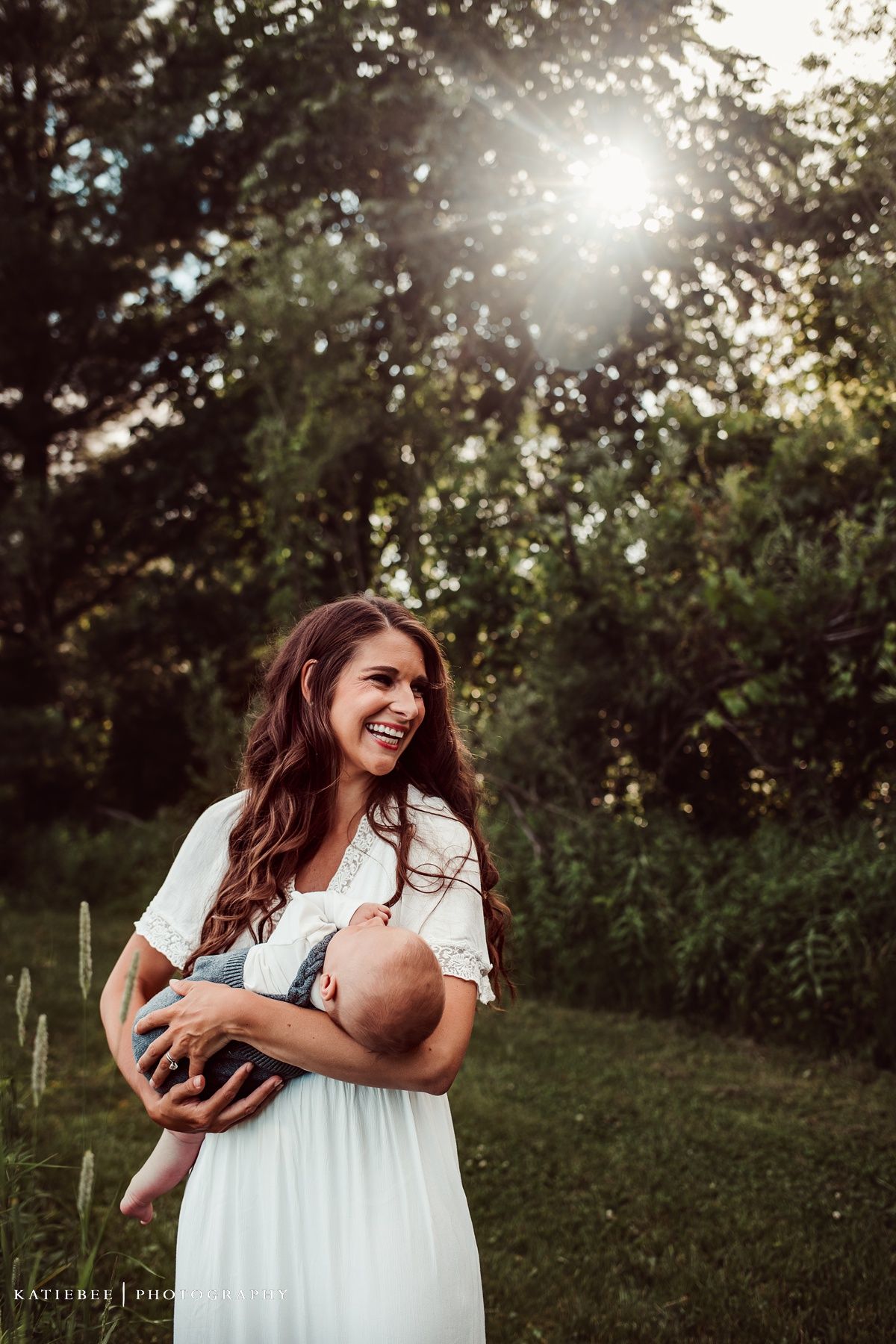 Radiant outdoor portrait with sunlight streaming through trees in a natural setting.