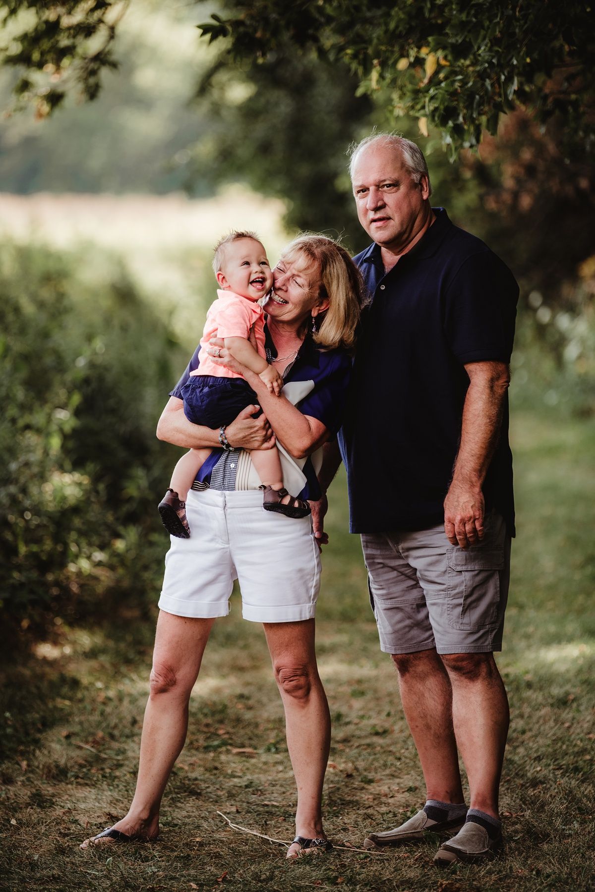 A relaxed family portrait on a nature trail during golden hour.