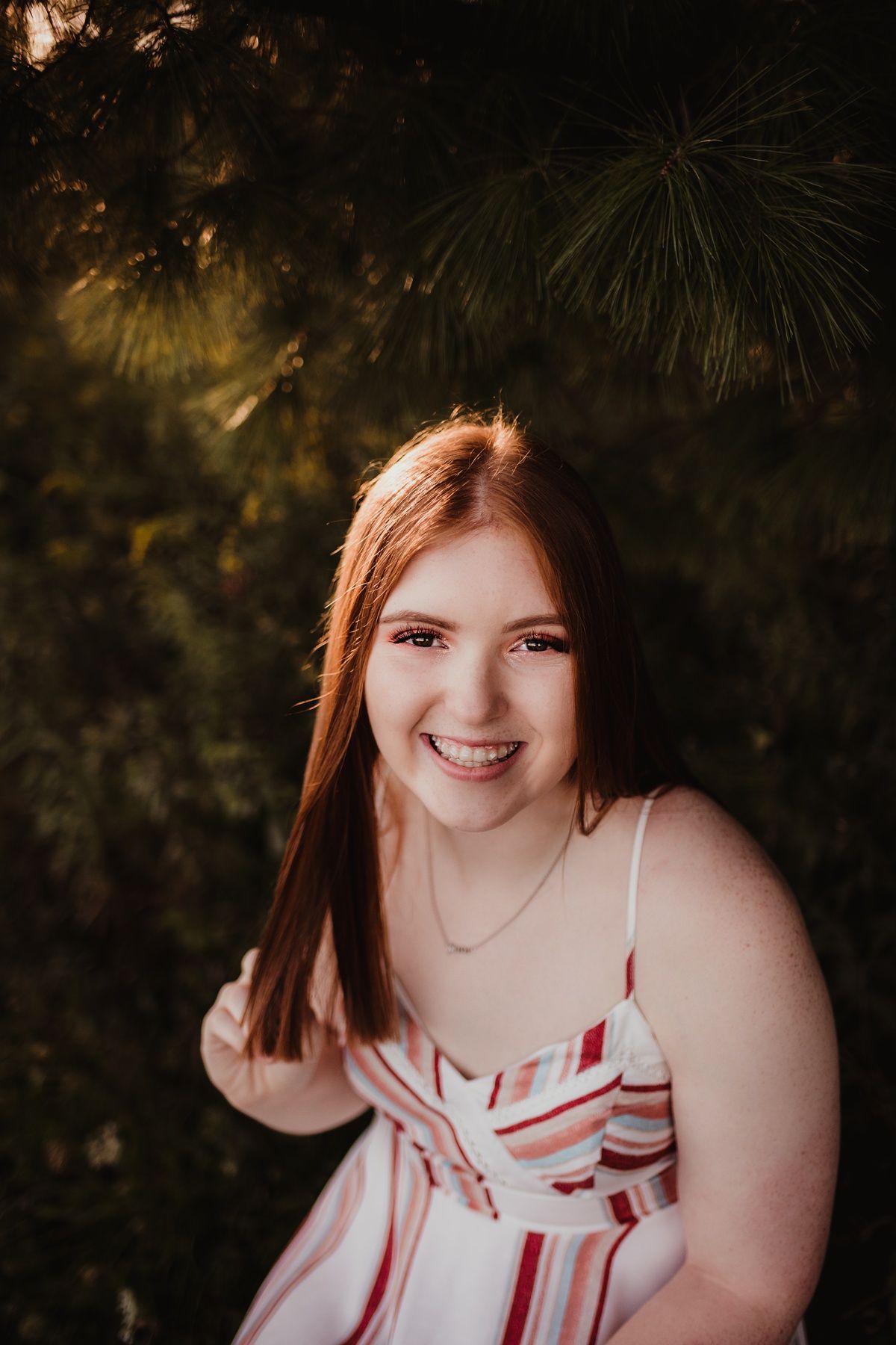 A joyful outdoor portrait with warm sunset lighting and natural styling.