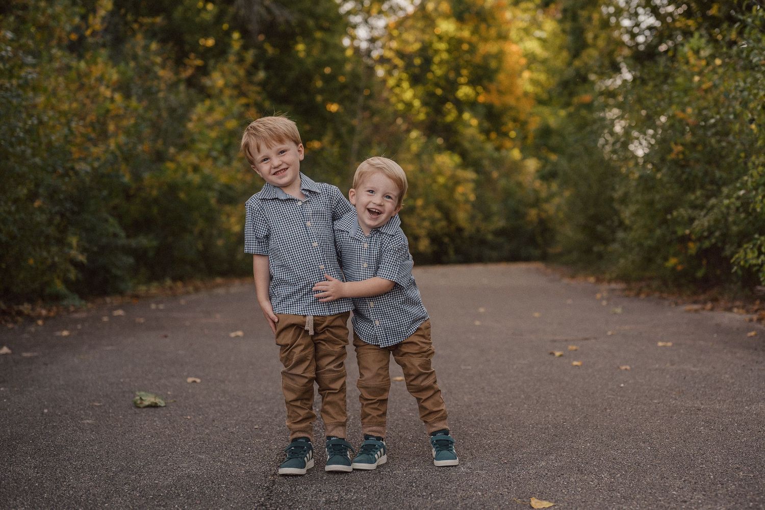A series of candid outdoor family portraits taken in a park setting during golden hour with autumn trees in background.