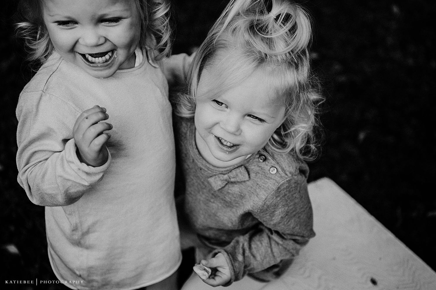 Close-up black and white portrait capturing pure childhood joy and laughter.