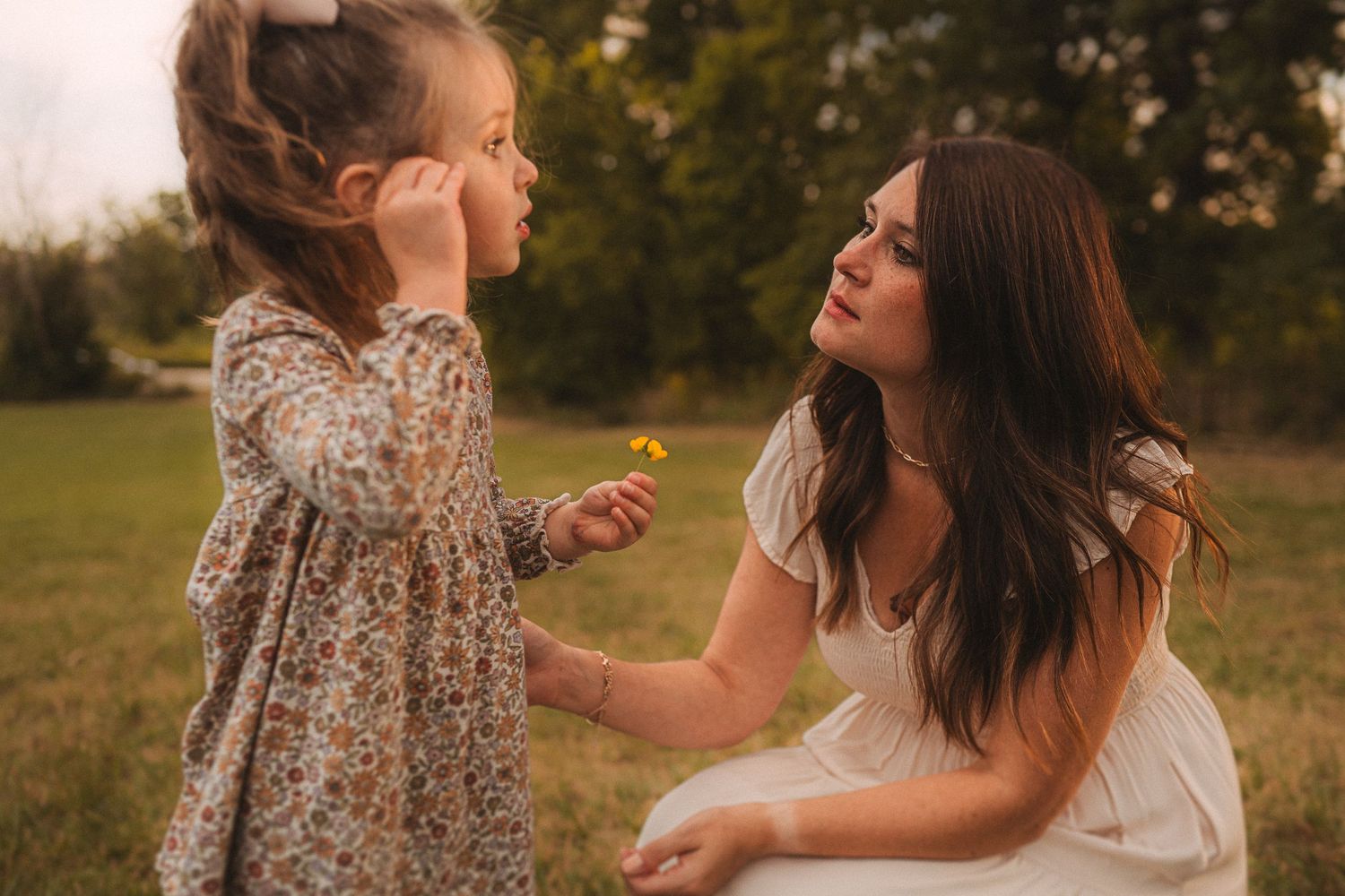 Tender moment shared between two people outdoors during golden hour.