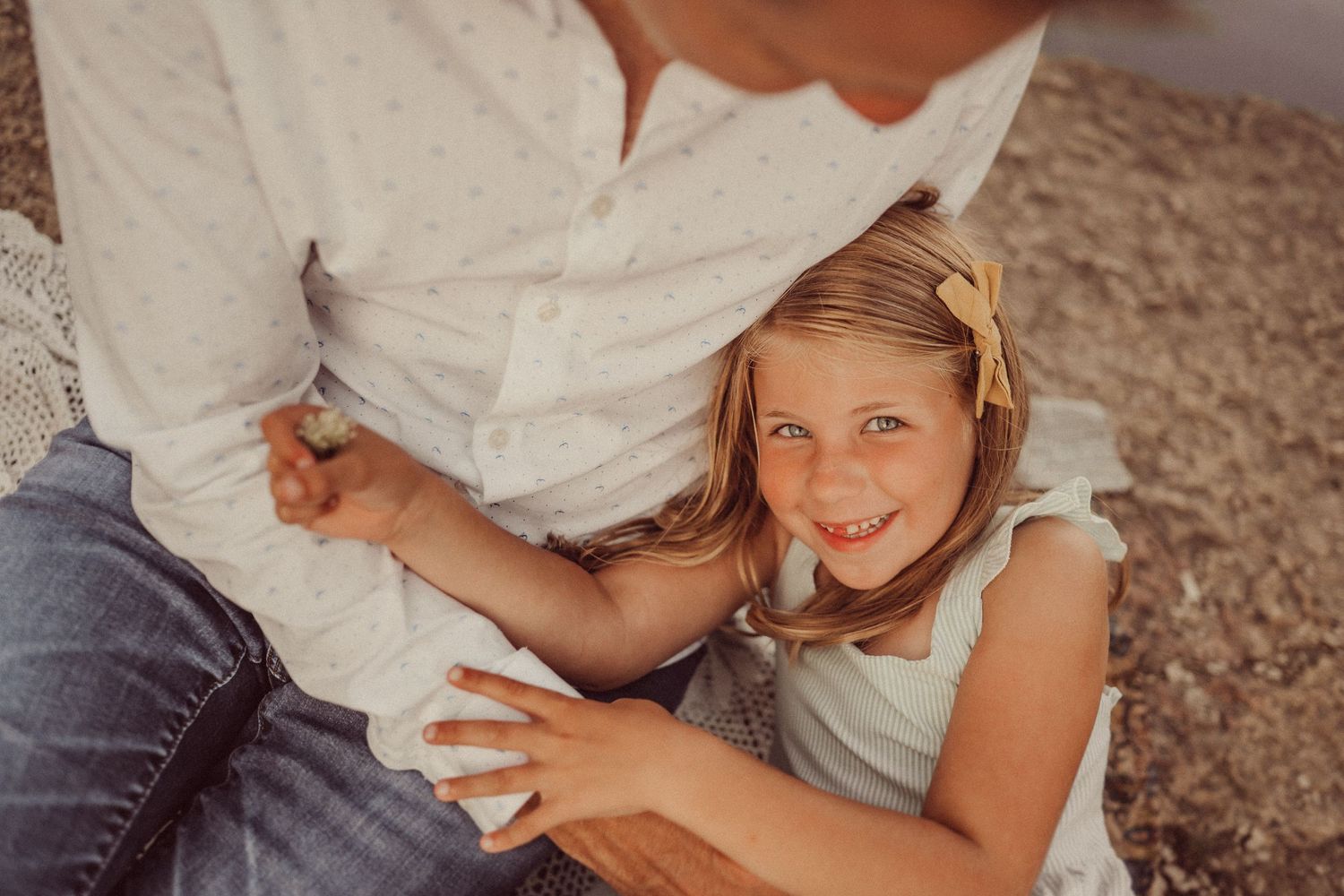 Candid close-up shot of joyful interaction during outdoor family photoshoot.