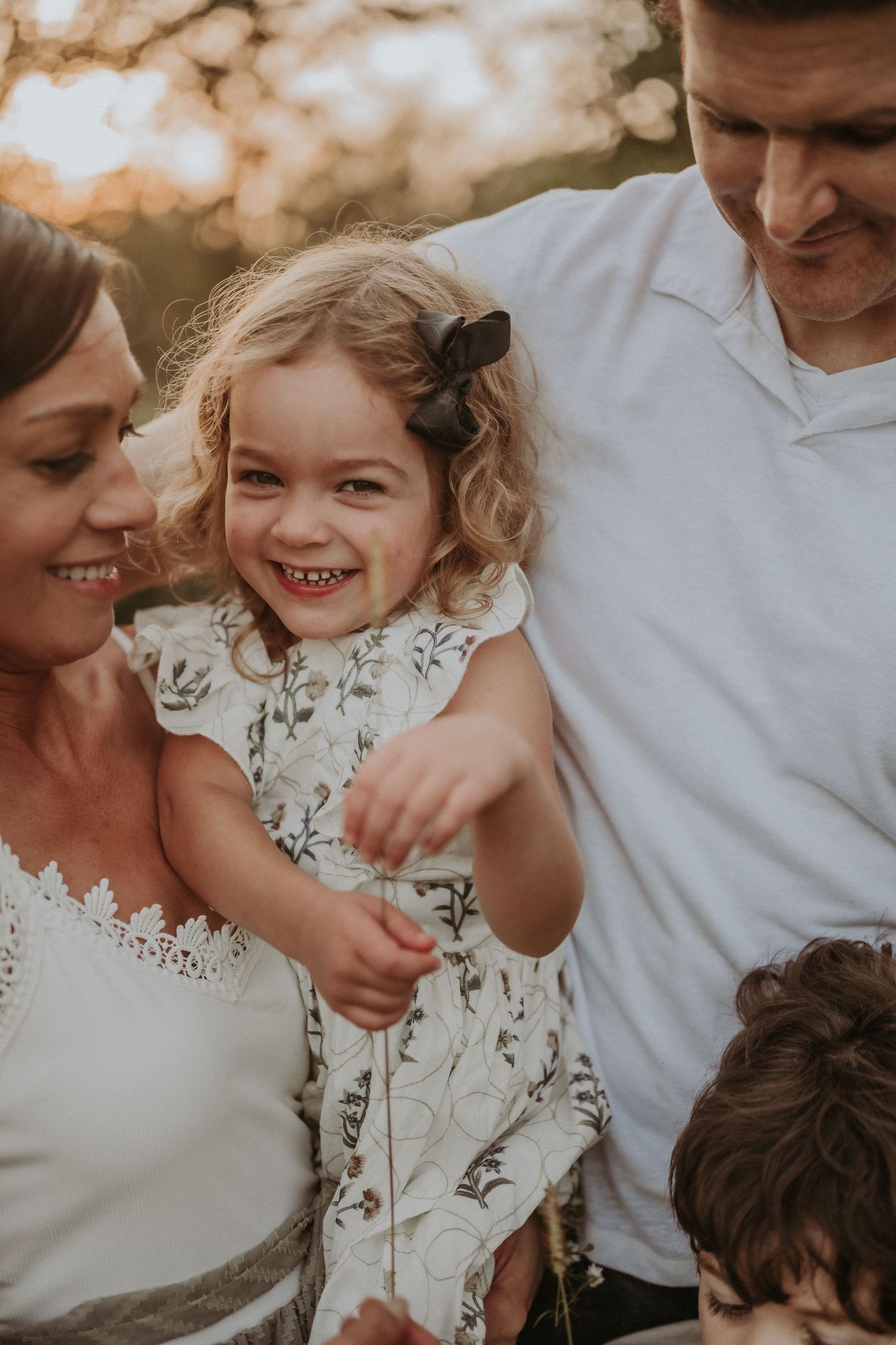 A joyful family moment captured in warm sunset light.