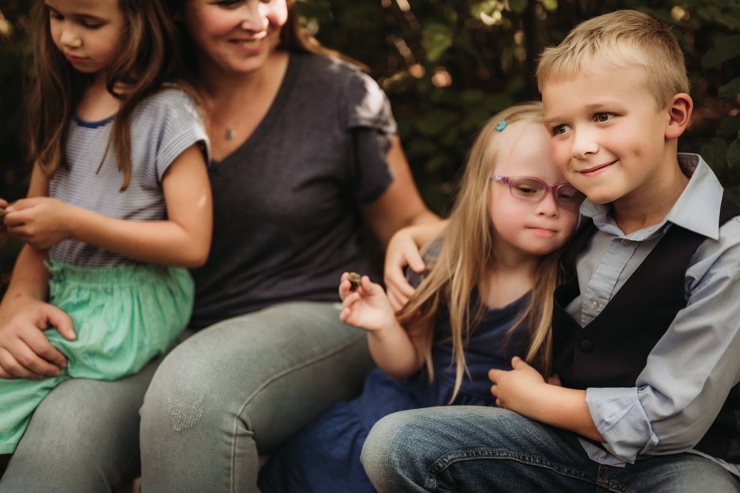 A casual outdoor family portrait shows everyone relaxing together.