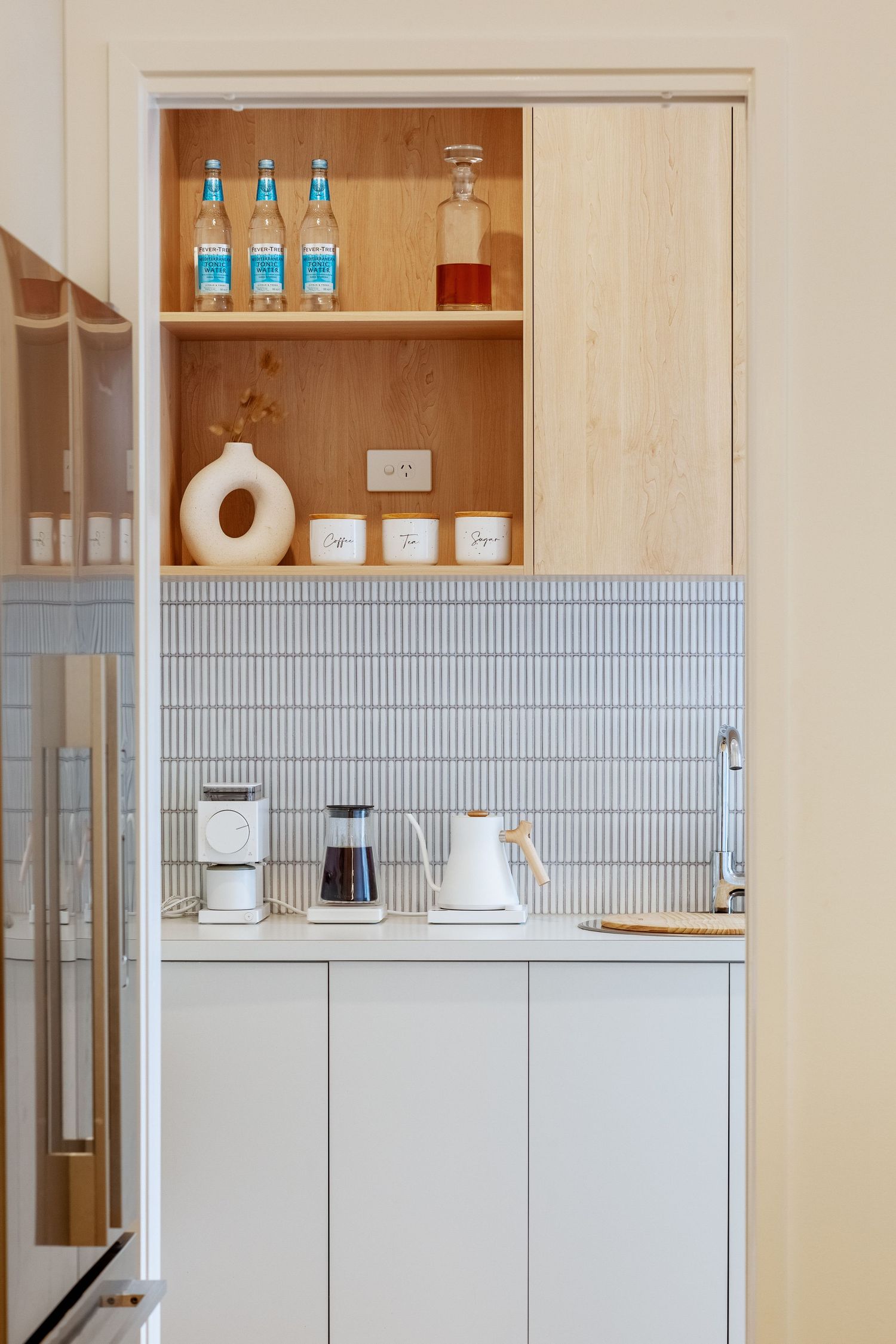 Sunshine Coast real estate photography: modern butler's pantry with white vertical kit-kat tiles, light timber shelving, and premium coffee