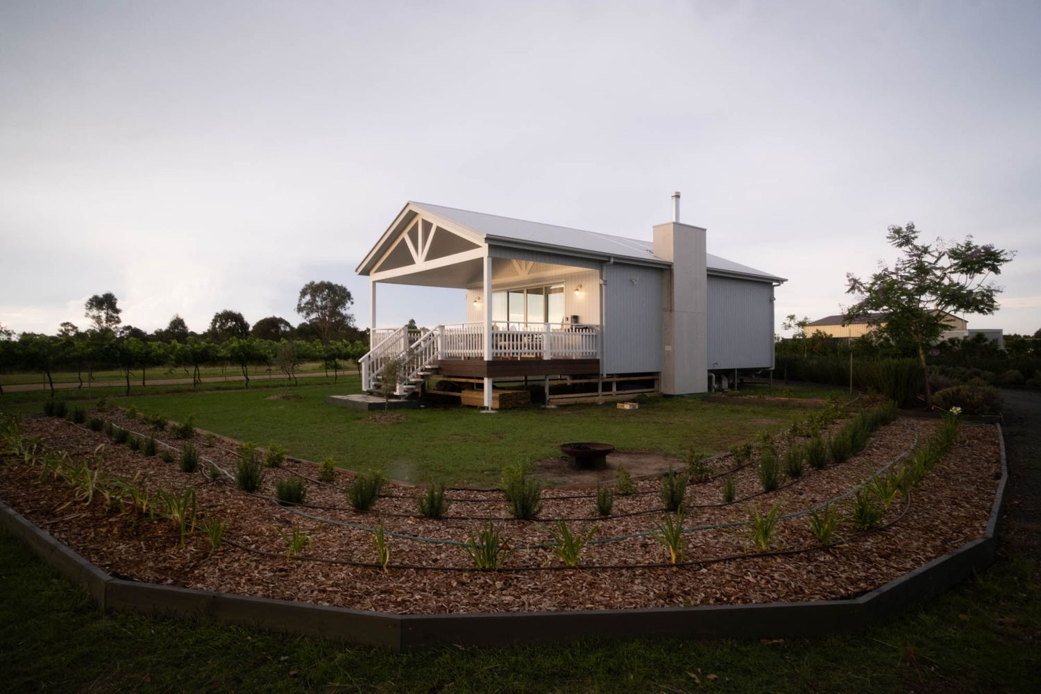 Sunshine Coast real estate photography: modern white weatherboard cabin with an architectural gabled porch
