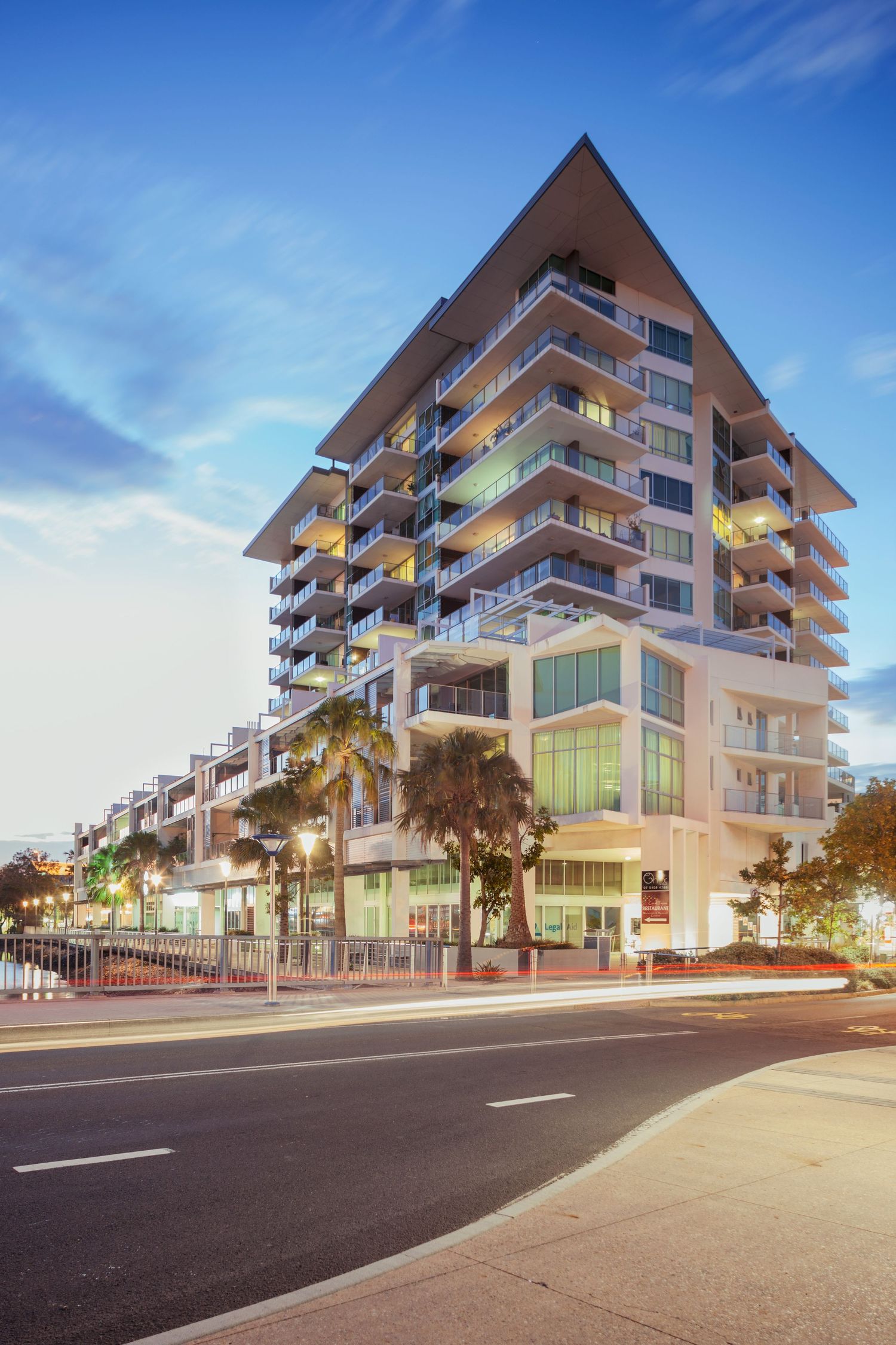 Sunshine Coast real estate photography: M1 building Maroochydore at twilight with luxury architectural lighting and coastal palm trees