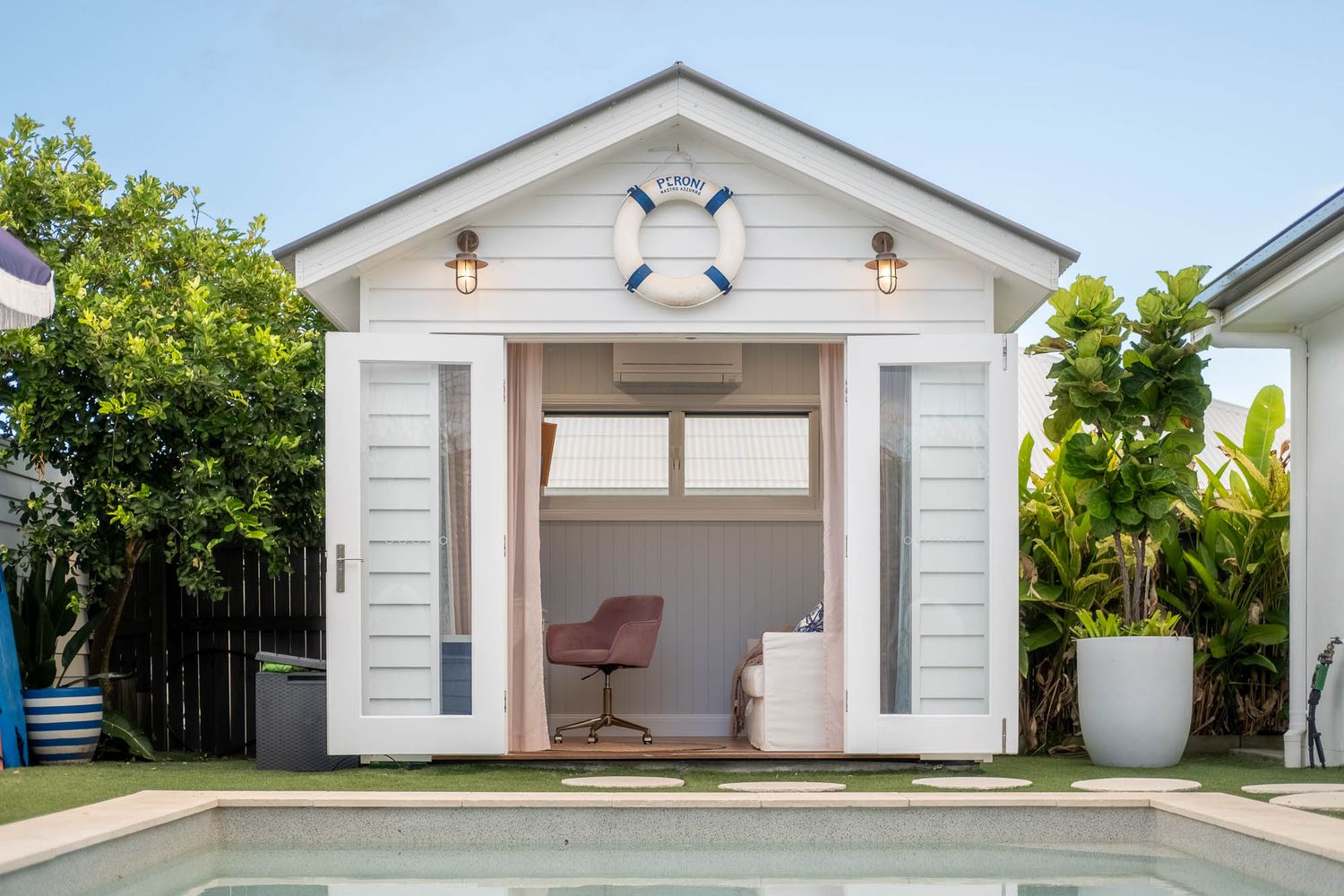 Sunshine Coast real estate photography: luxury pool house studio with nautical decor, white weatherboard, and pool area