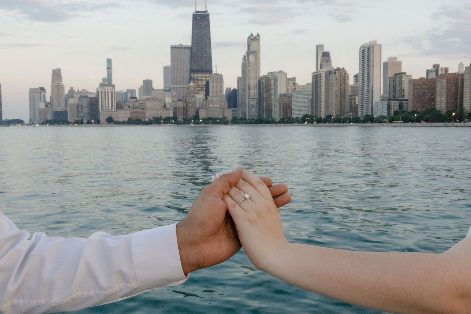 Chicago skyline view from Lake Michigan with hands reaching across the frame.