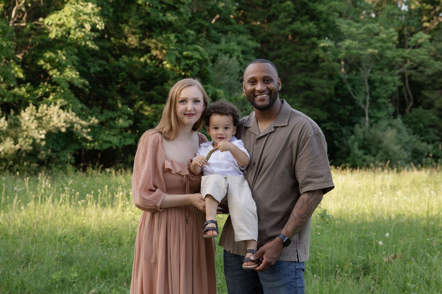 Family enjoying a candid moment together outdoors in a natural setting.