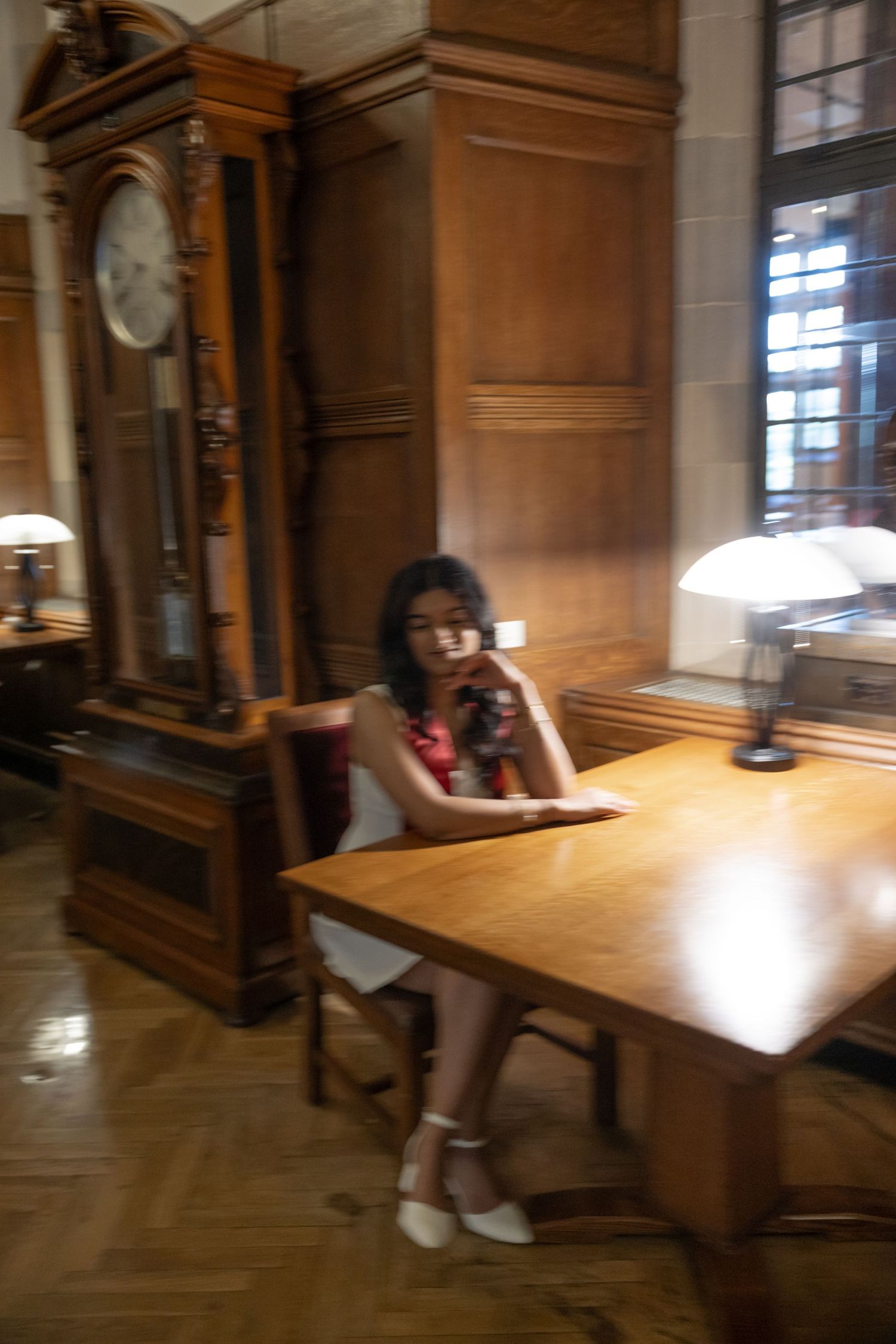 A sequence shows movement in an indoor study space with wooden furniture and warm lighting.