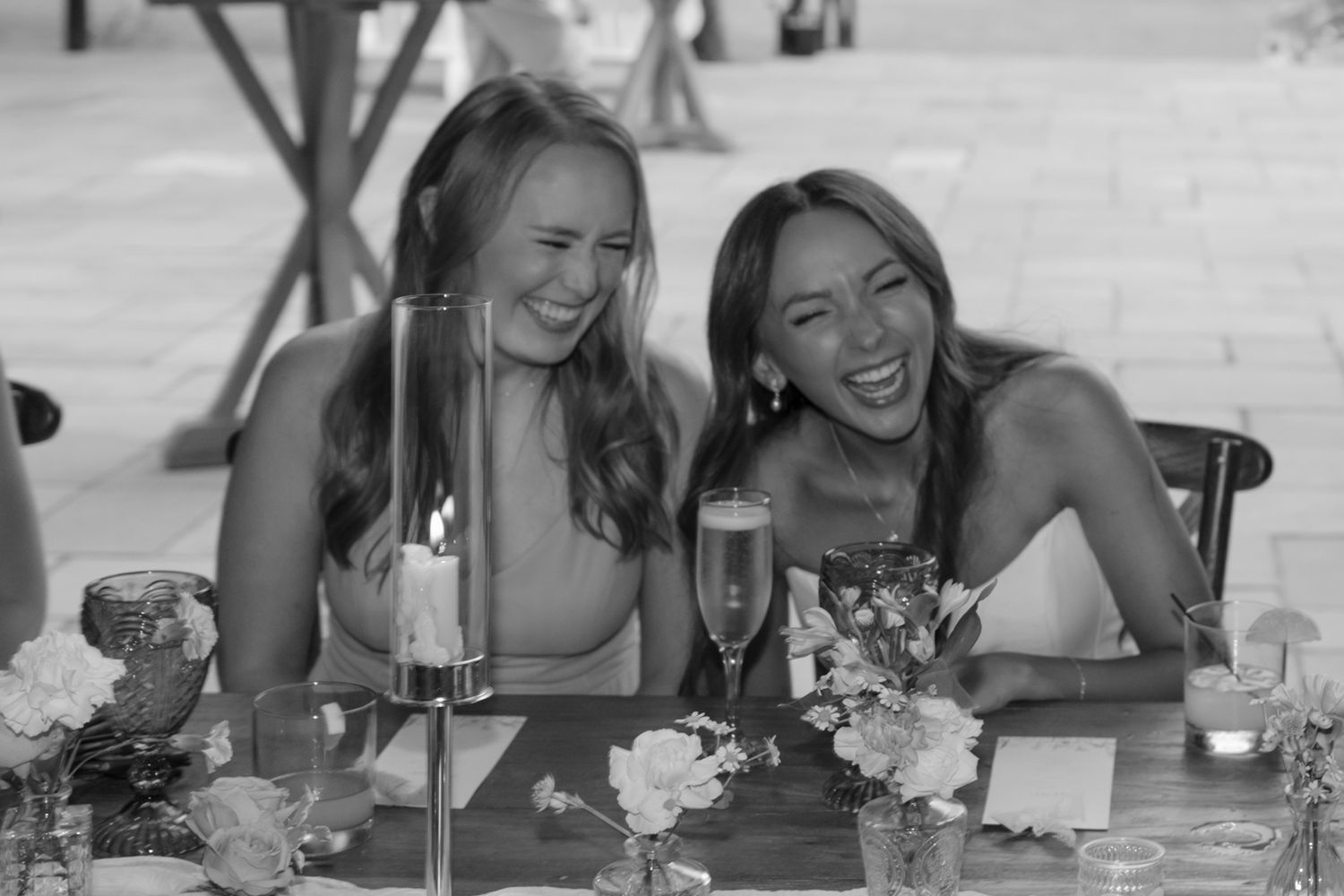 Candid moments of laughter and joy shared during wedding reception dinner.