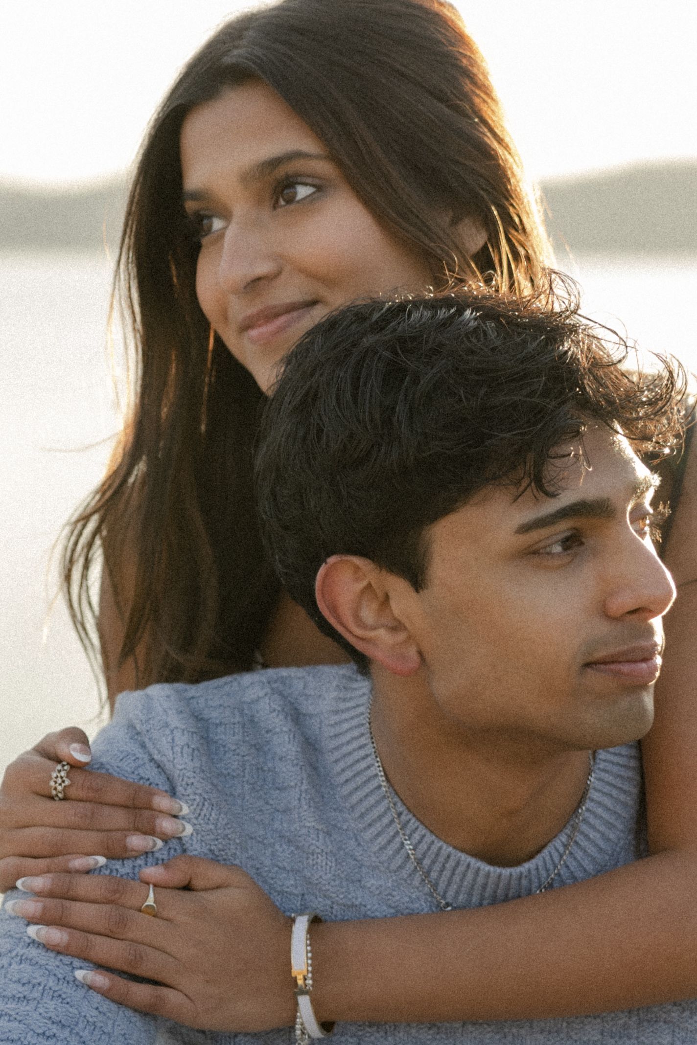 Romantic beach photoshoot of a couple during golden hour.