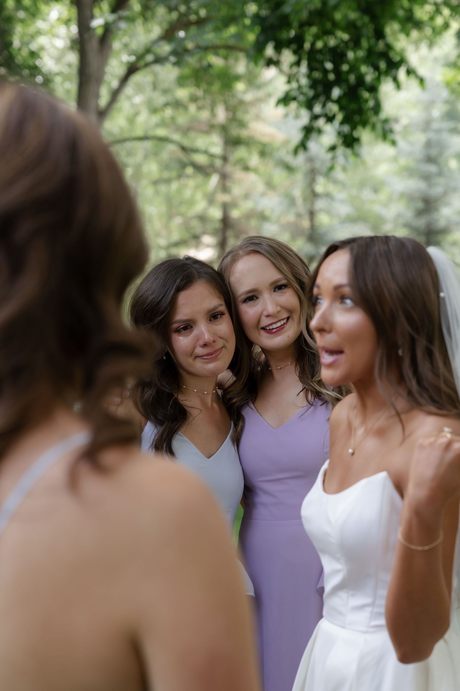 Wedding party shares joyful laughs together during outdoor photo session.