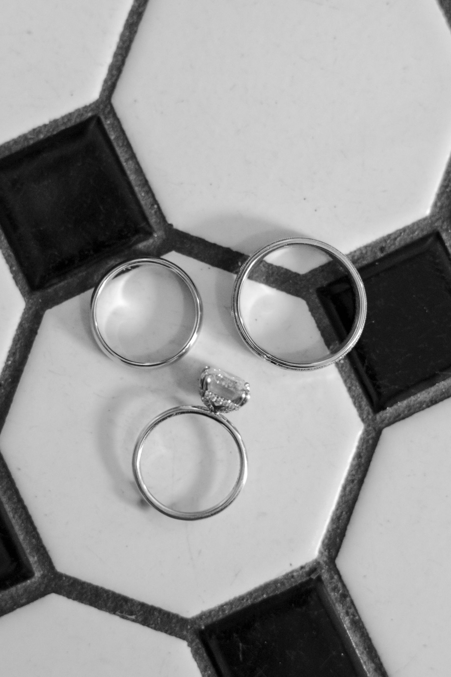 Wedding rings displayed on a black velvet cushion in multiple artistic angles.