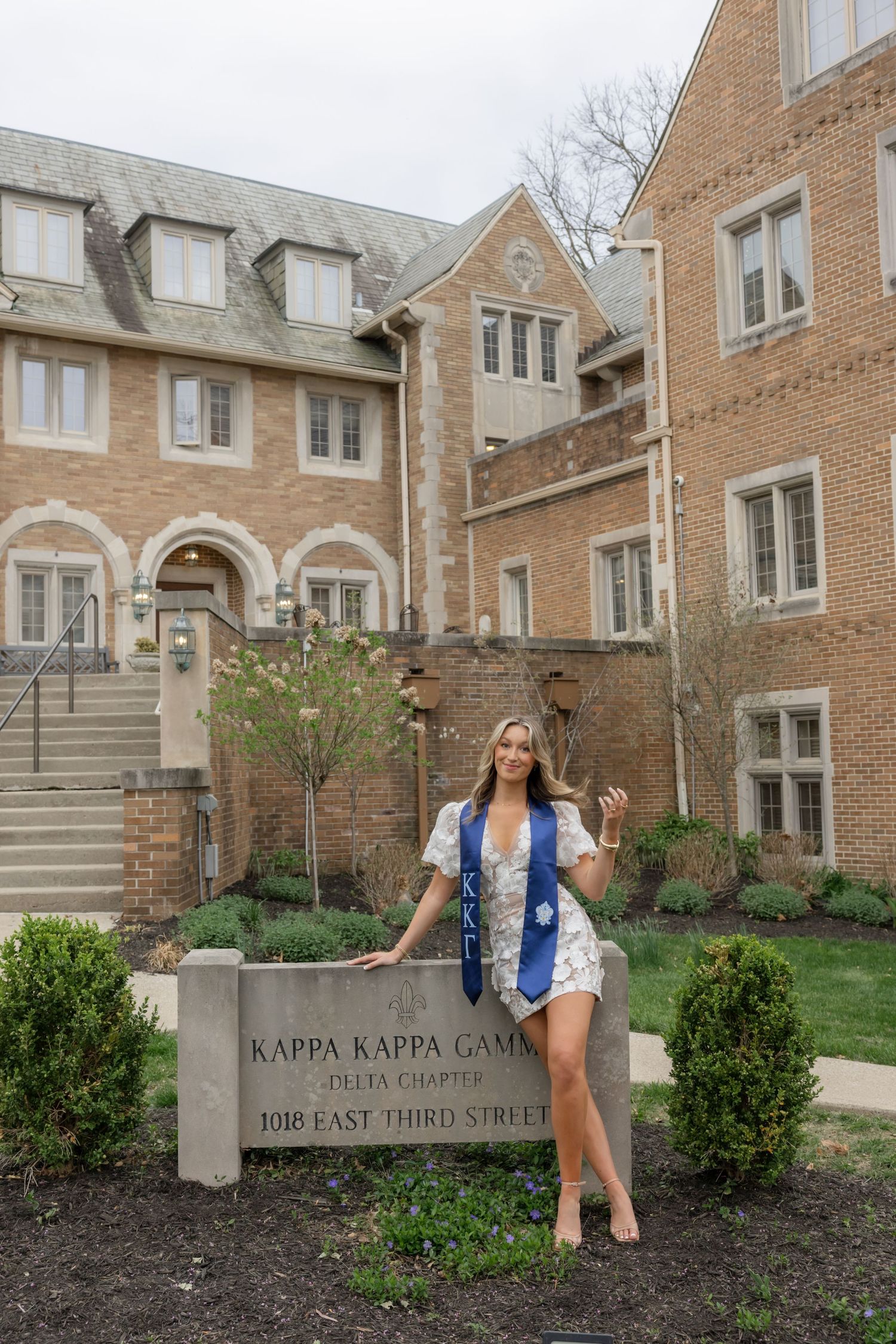 Views of a brick sorority house with Kappa Kappa Gamma signage and landscaping.