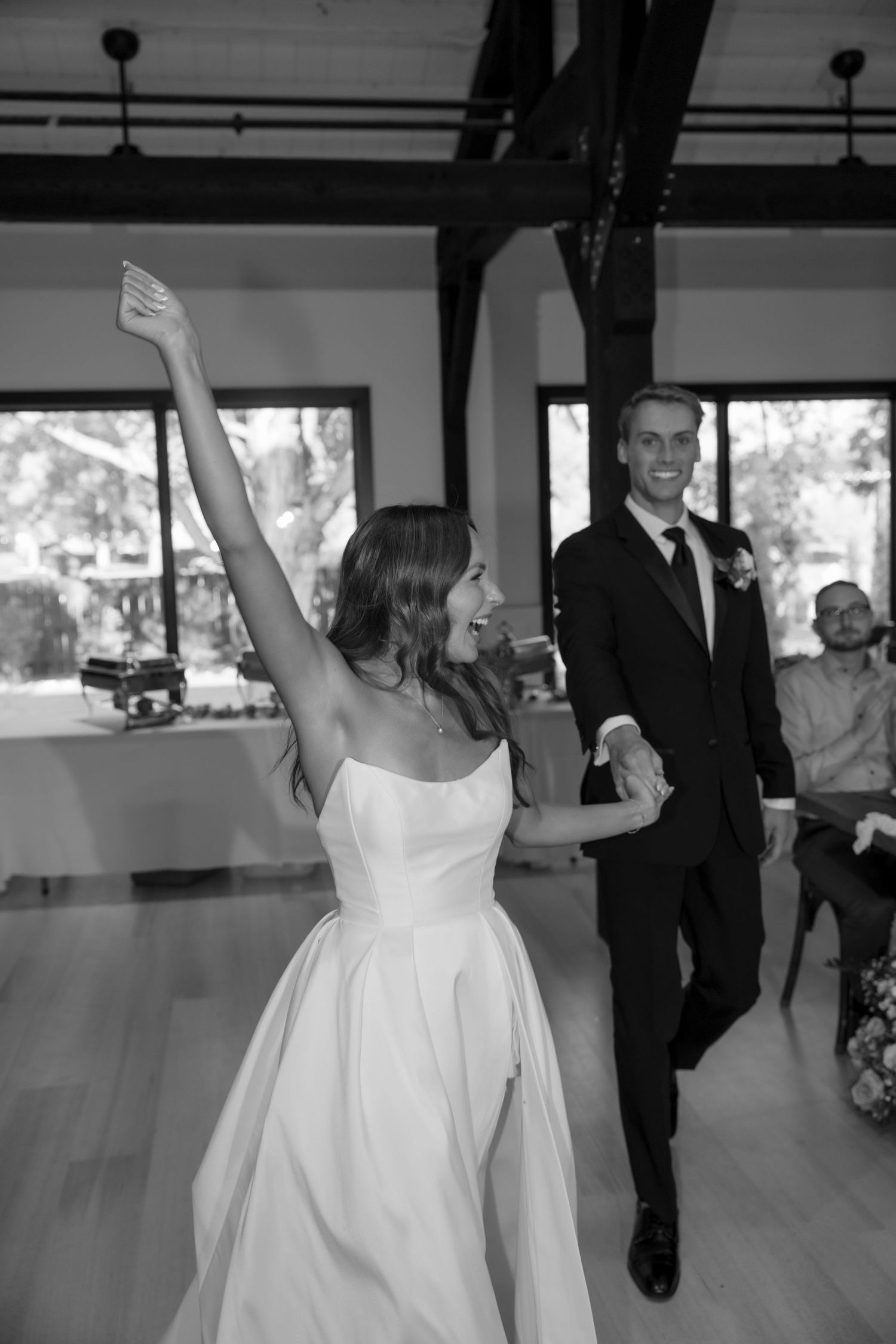 Wedding celebration captures joyful dancing moments in black and white photography.