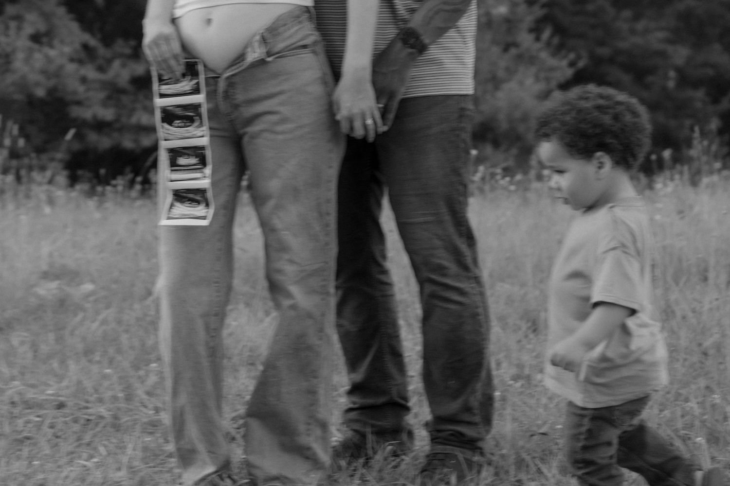 Black and white photo of a family group standing together outdoors.