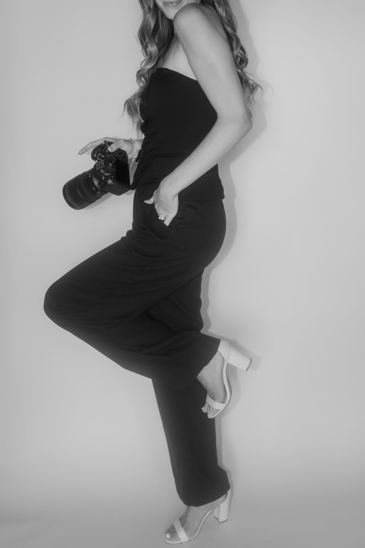 Dynamic poses in black and white showing movement in a black outfit against white background.
