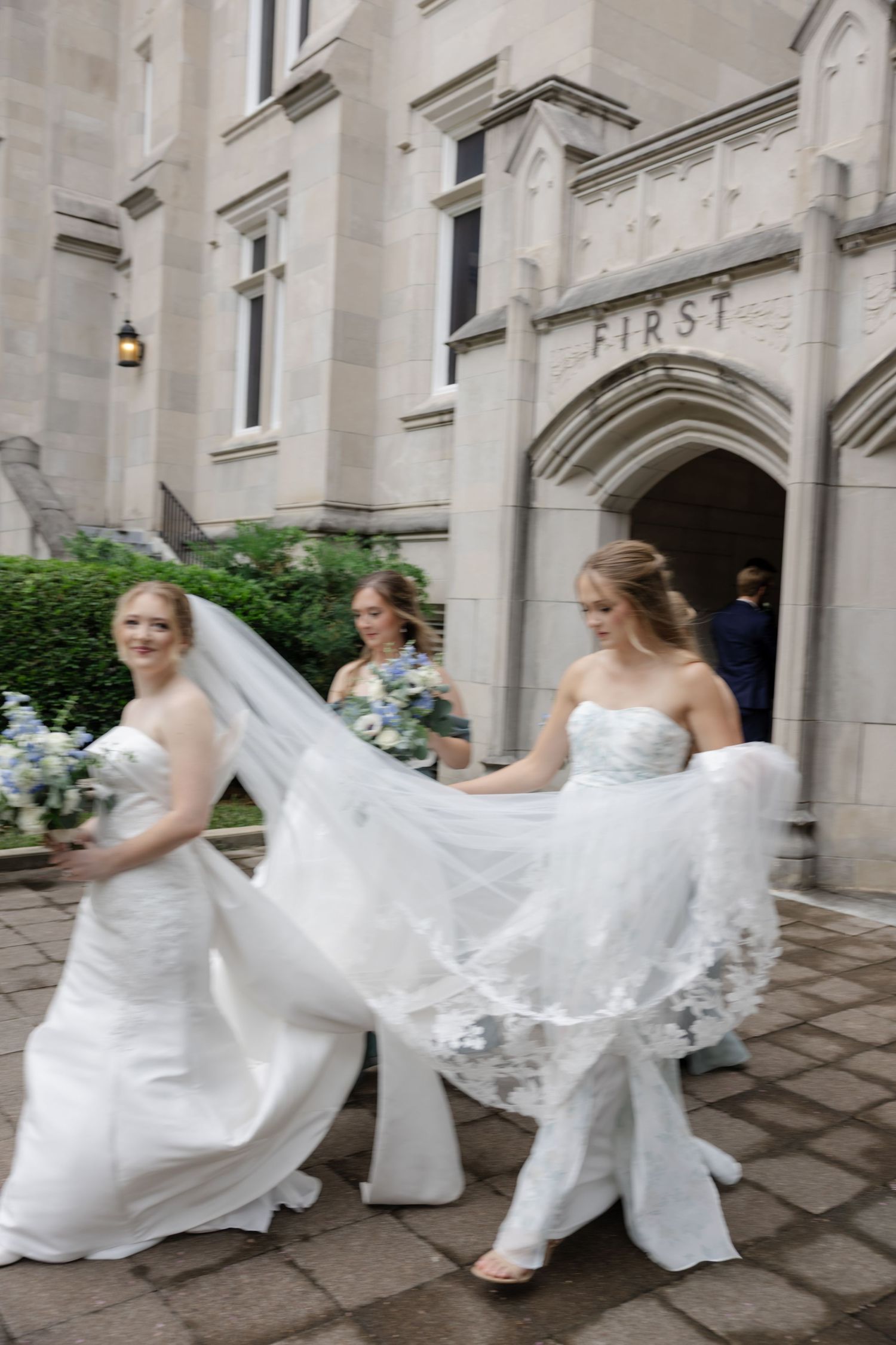 A sequence of frames showing a wedding dress being displayed in motion against an elegant stone building.