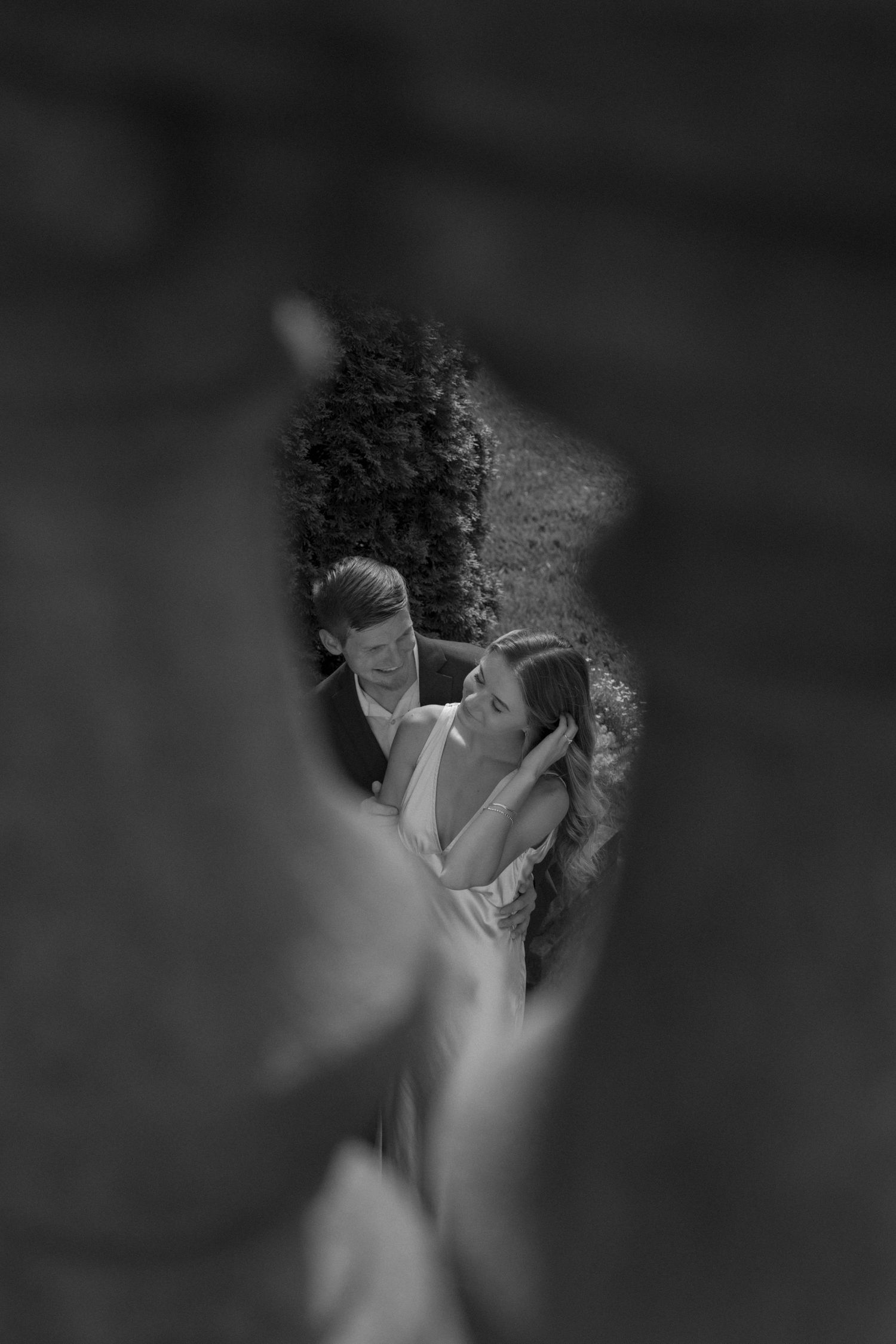 Intimate black and white portrait showing tender romantic moment.