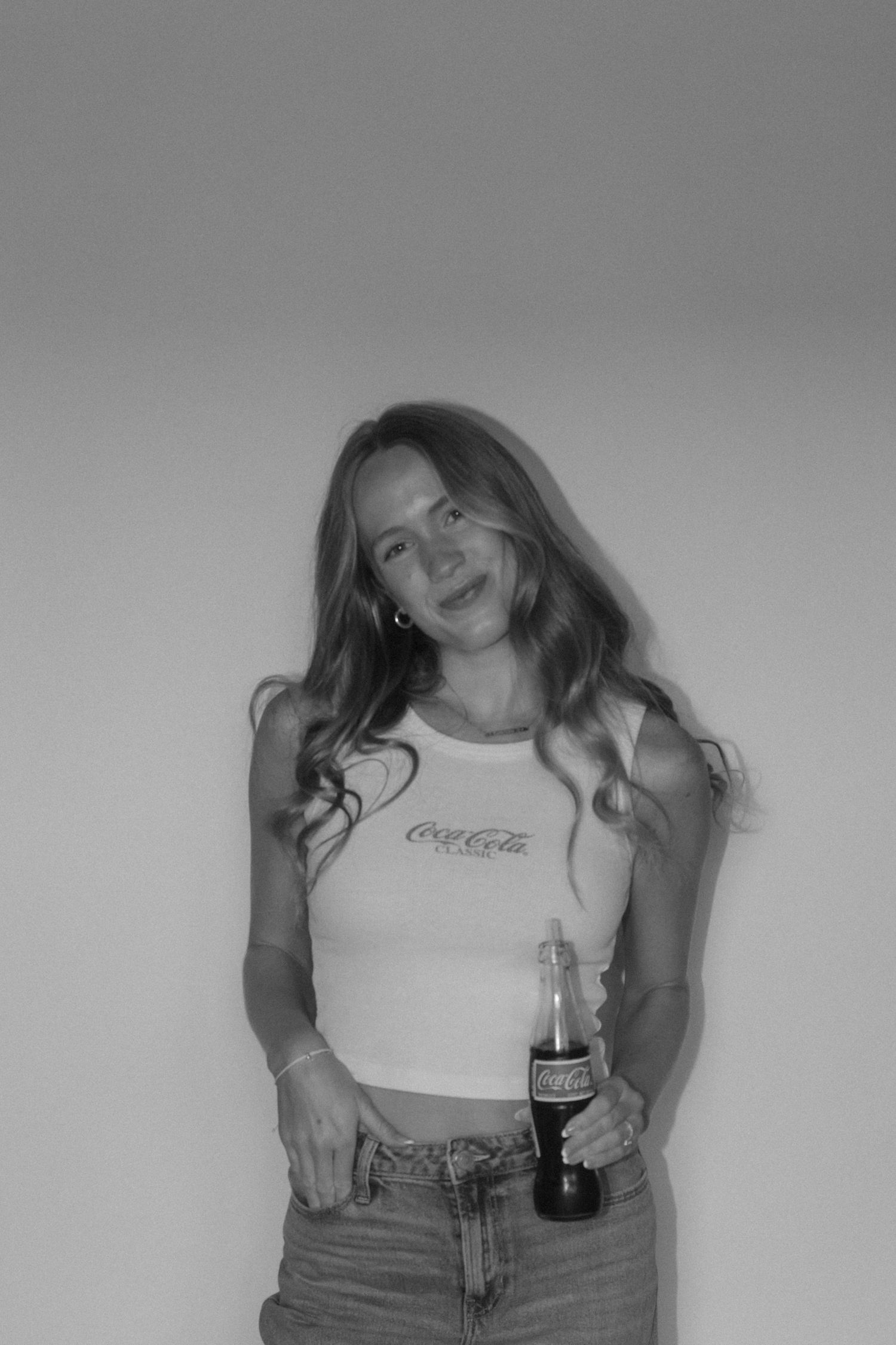 Black and white portrait series in casual attire against studio backdrop.