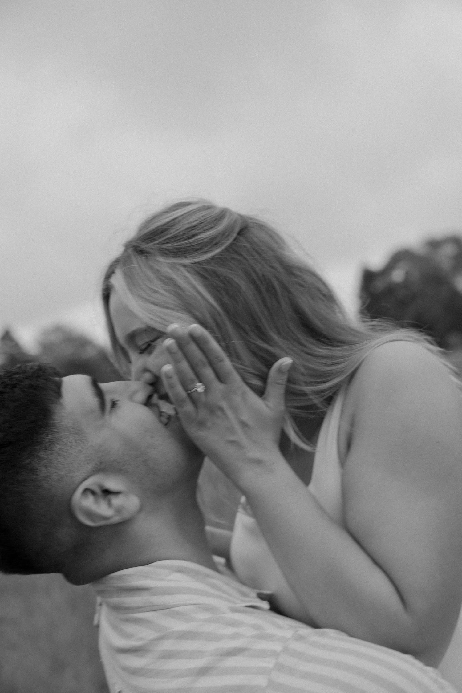 An artistic black and white capture of an intimate moment between two people.