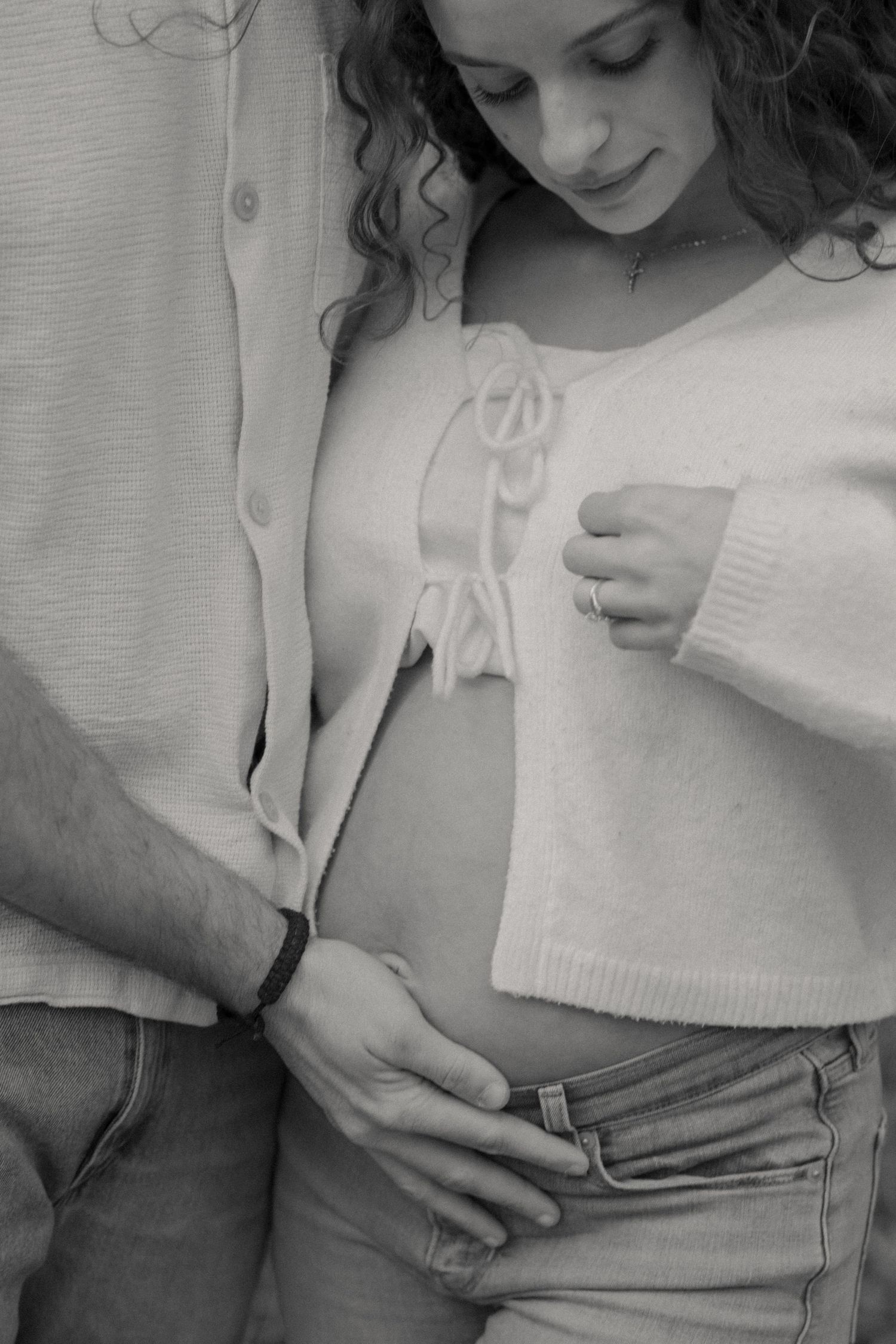 Close-up black and white shots of couple during intimate maternity session.