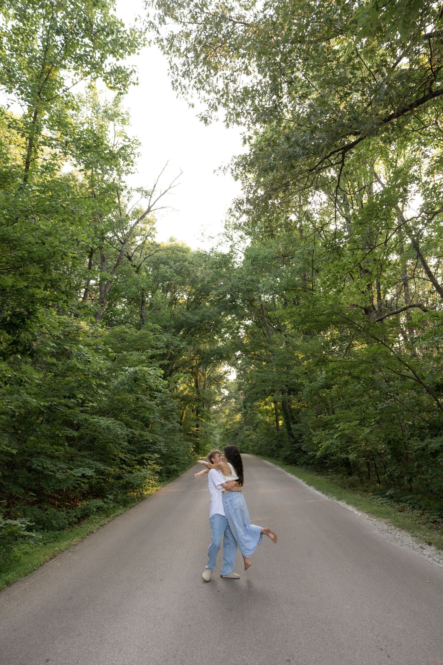 A sequence of romantic moments on a tree-lined path showing playful interactions.