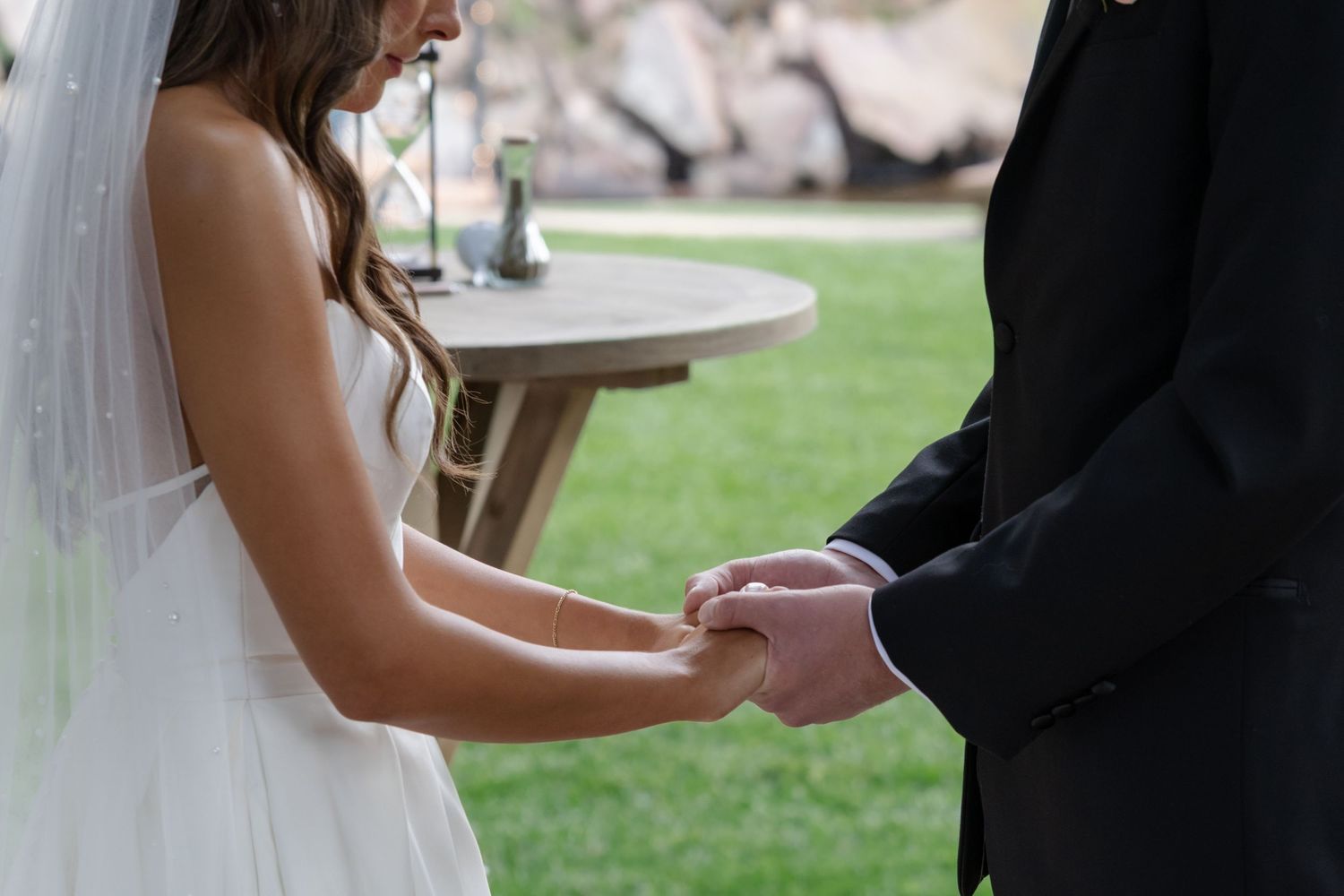 Intimate moments captured during outdoor wedding ceremony vow exchange.
