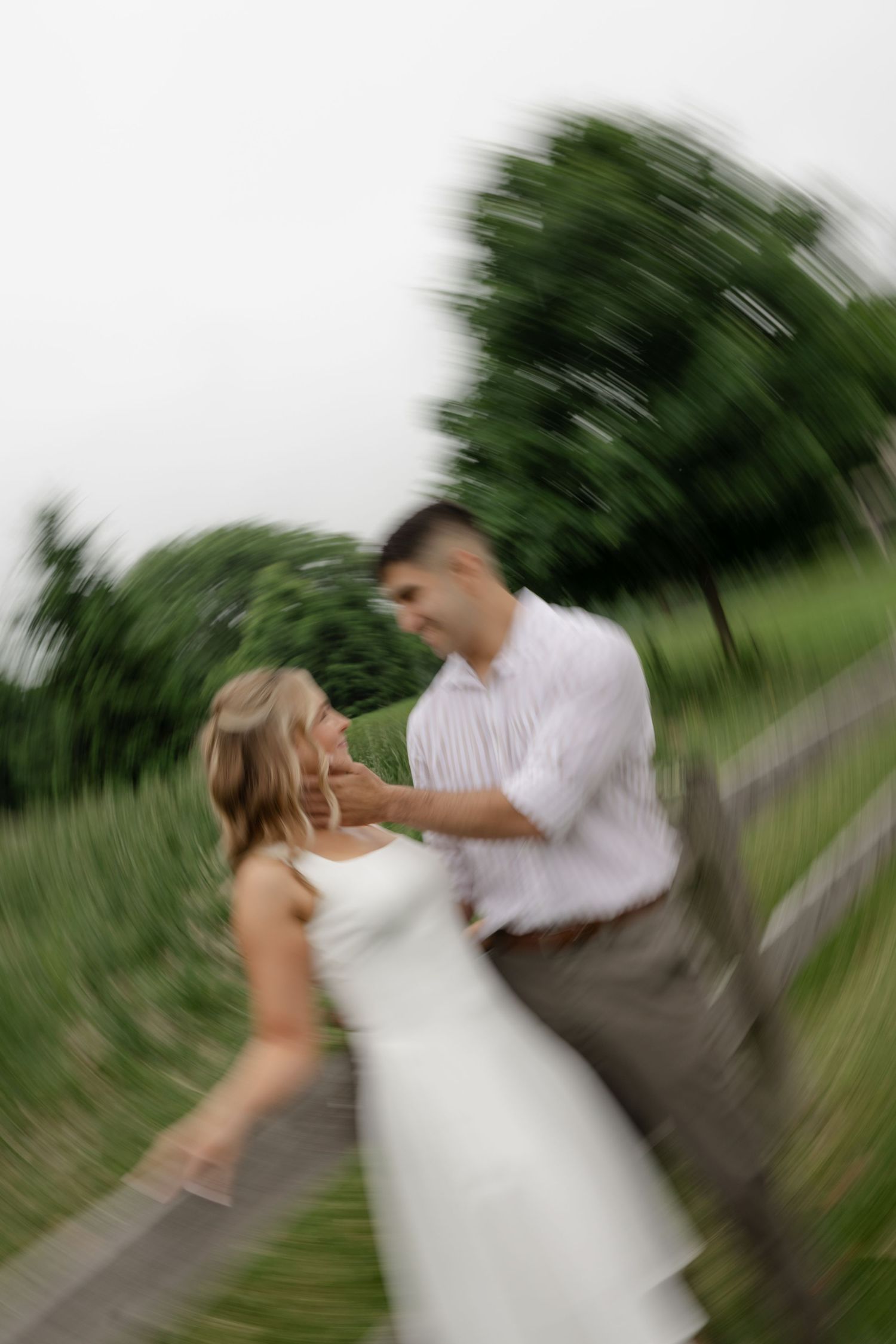 A couple dancing outdoors with motion blur creating a dynamic effect.