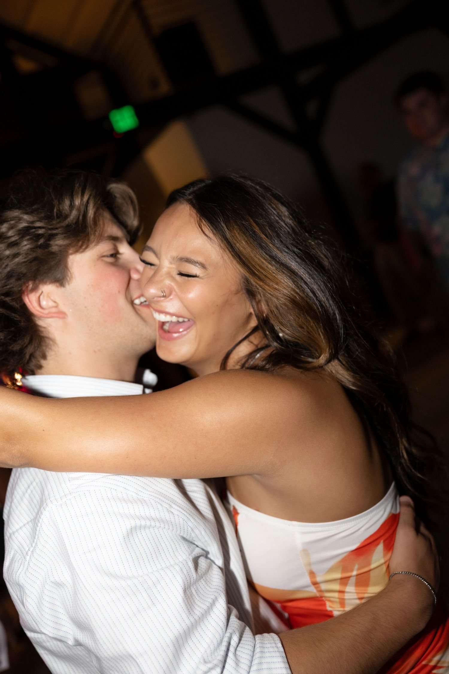 Two people sharing an intimate dance moment at a reception party.