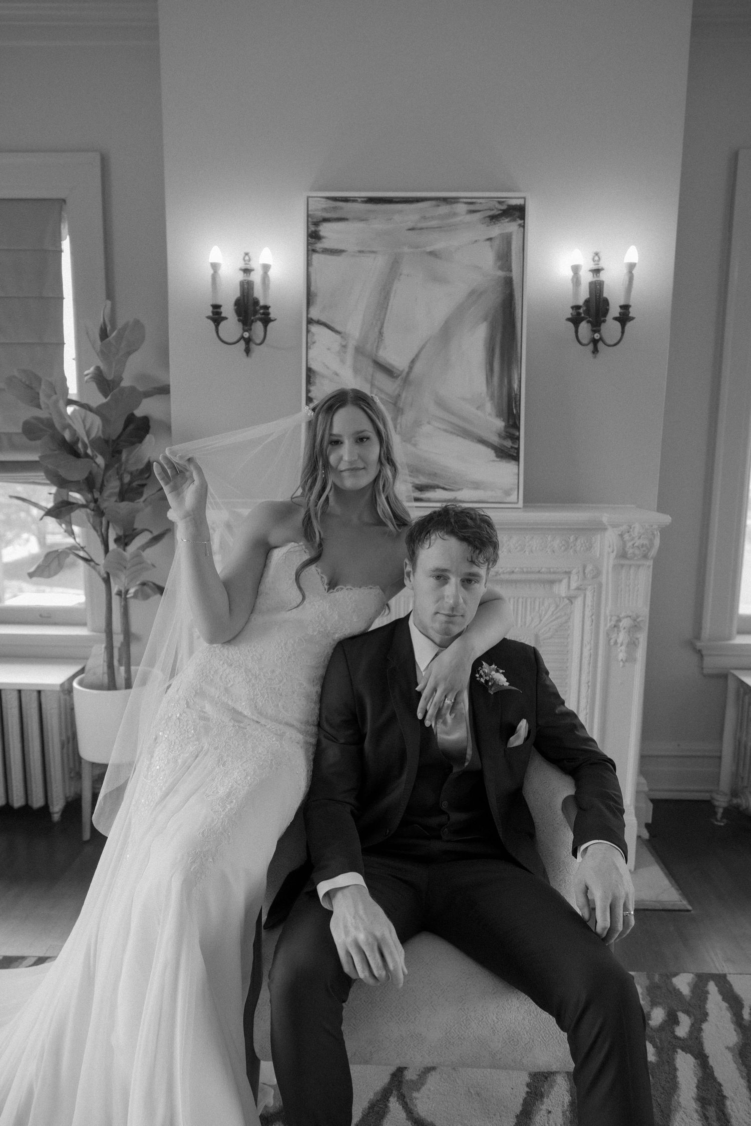 A collection of elegant black and white photos showing a couple seated in a formal indoor setting.