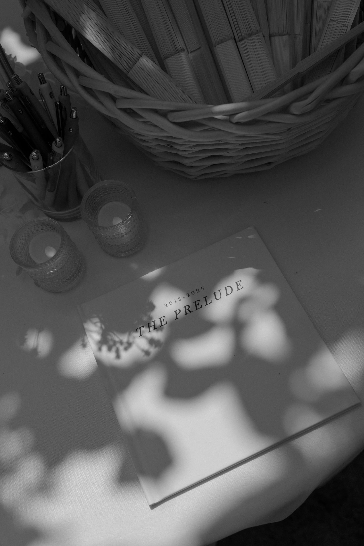 Artistic black and white photo of wedding details with shadow play.
