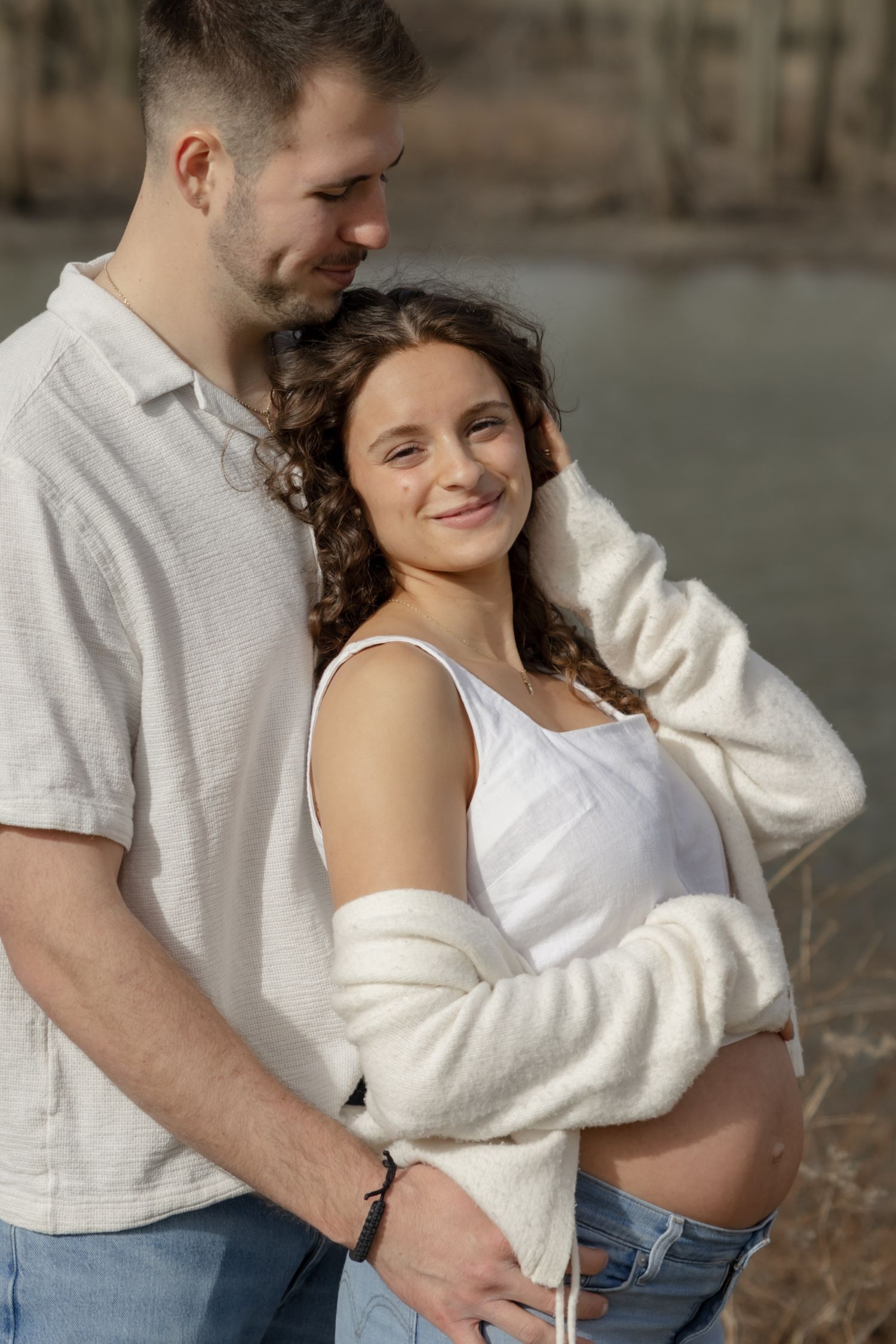 A romantic photoshoot sequence showing tender embraces in casual outfits.